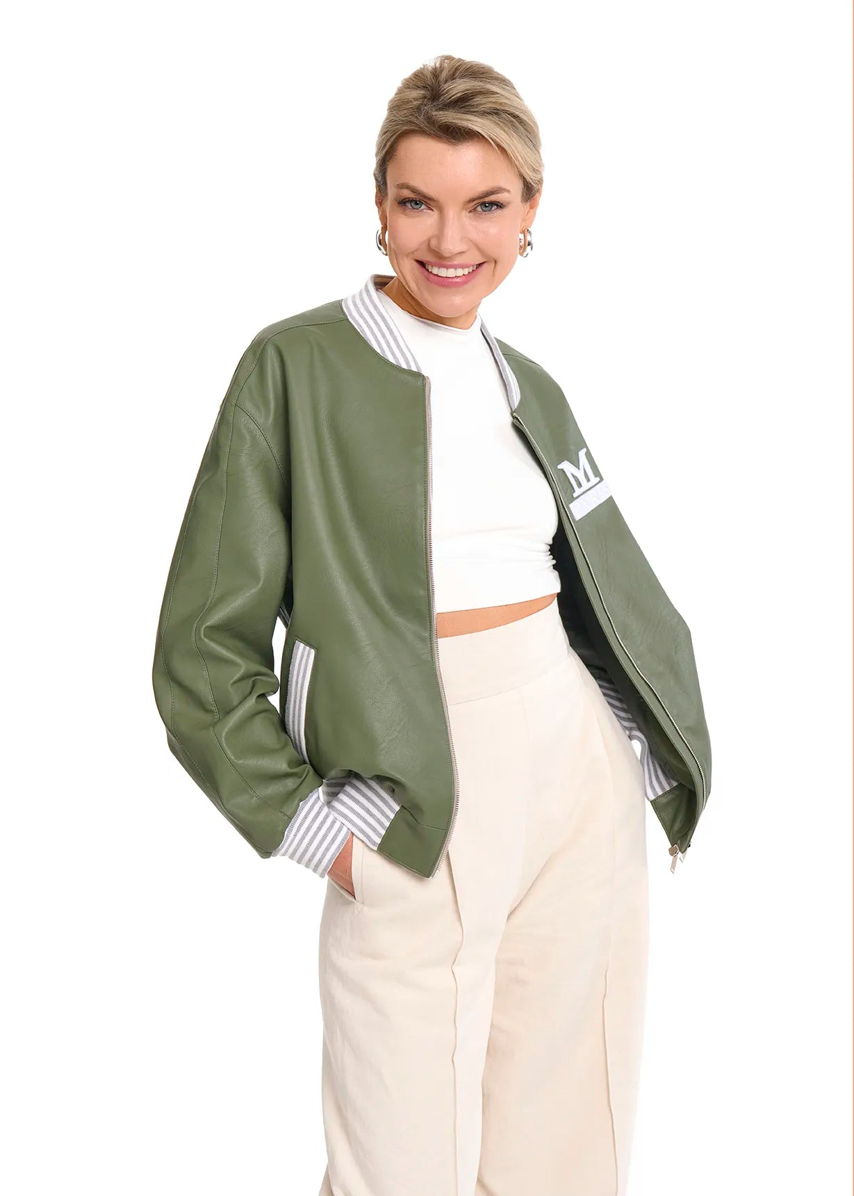 A woman wearing a white crop top and a green bomber jacket, showcasing a Mimaussy Paris 90s style fashion look.