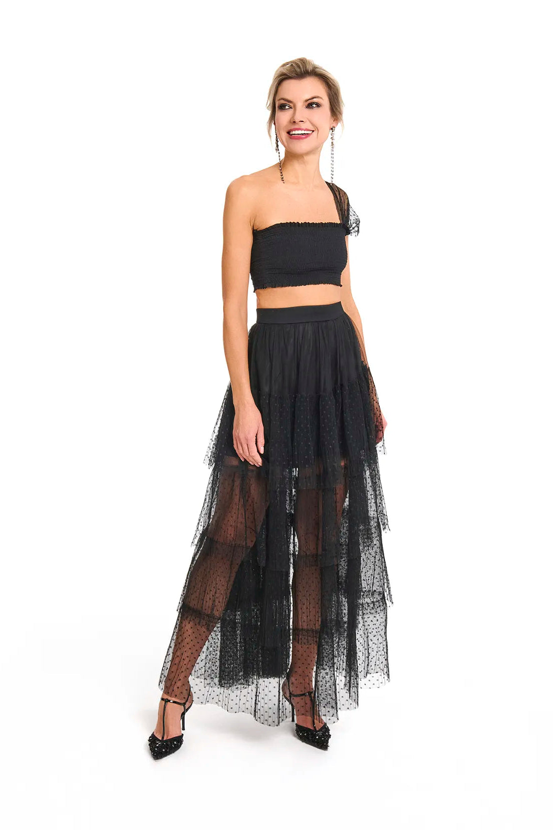 The woman dressed in a black crop top and tulle skirt, highlighting the Souflé Skirt in Phantom Black from Mimaussy Paris.