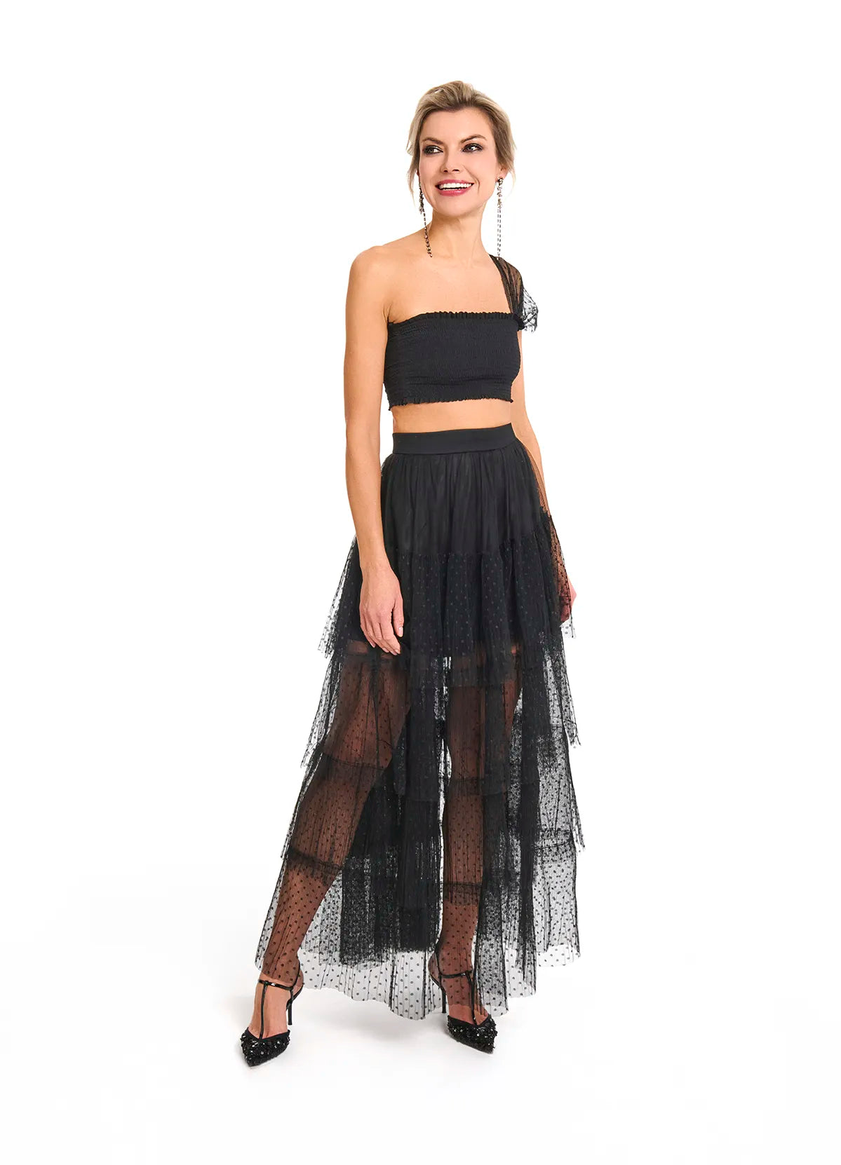 The woman dressed in a black crop top and tulle skirt, highlighting the Souflé Skirt in Phantom Black from Mimaussy Paris.