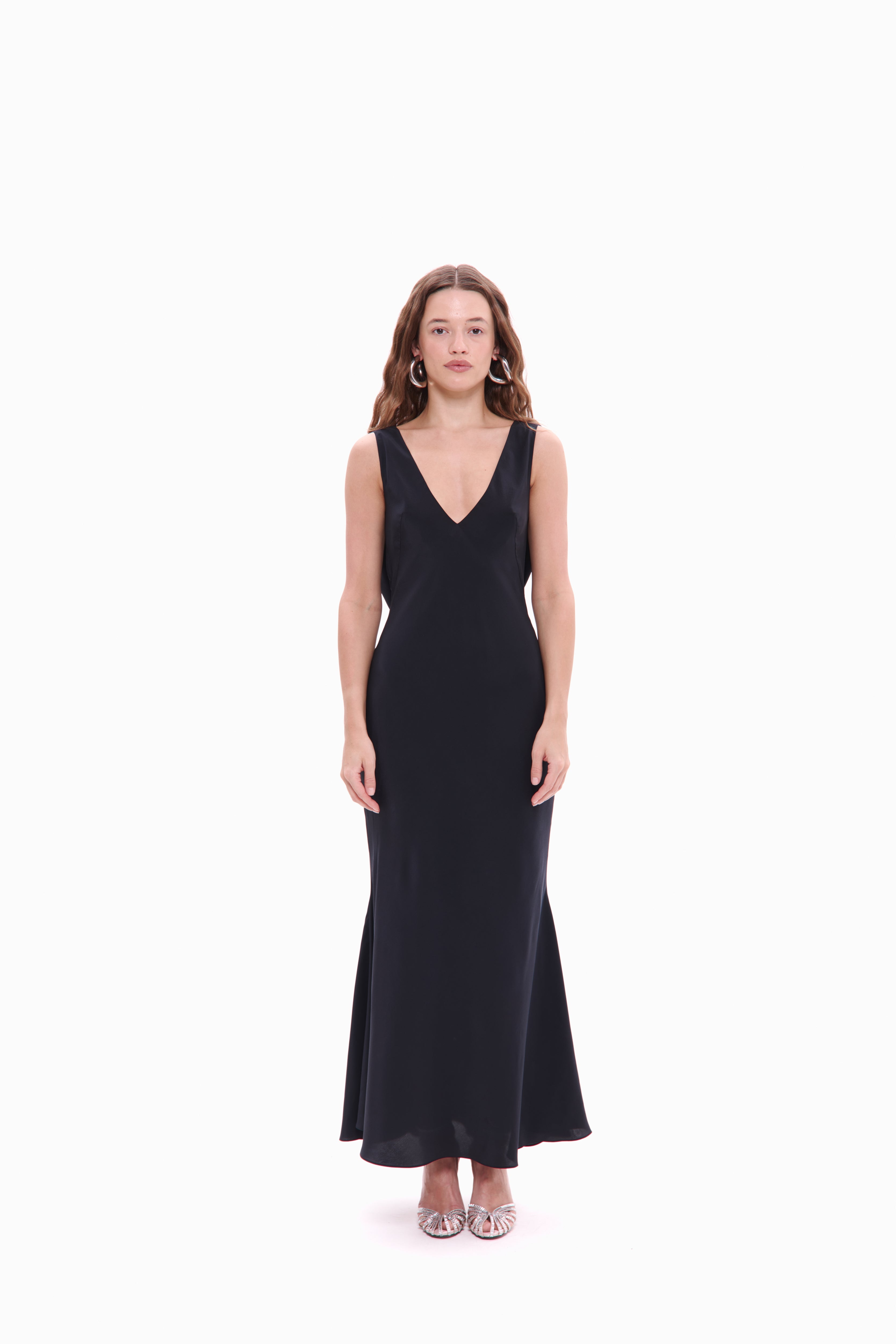 Woman wearing a black sleeveless dress on a white background