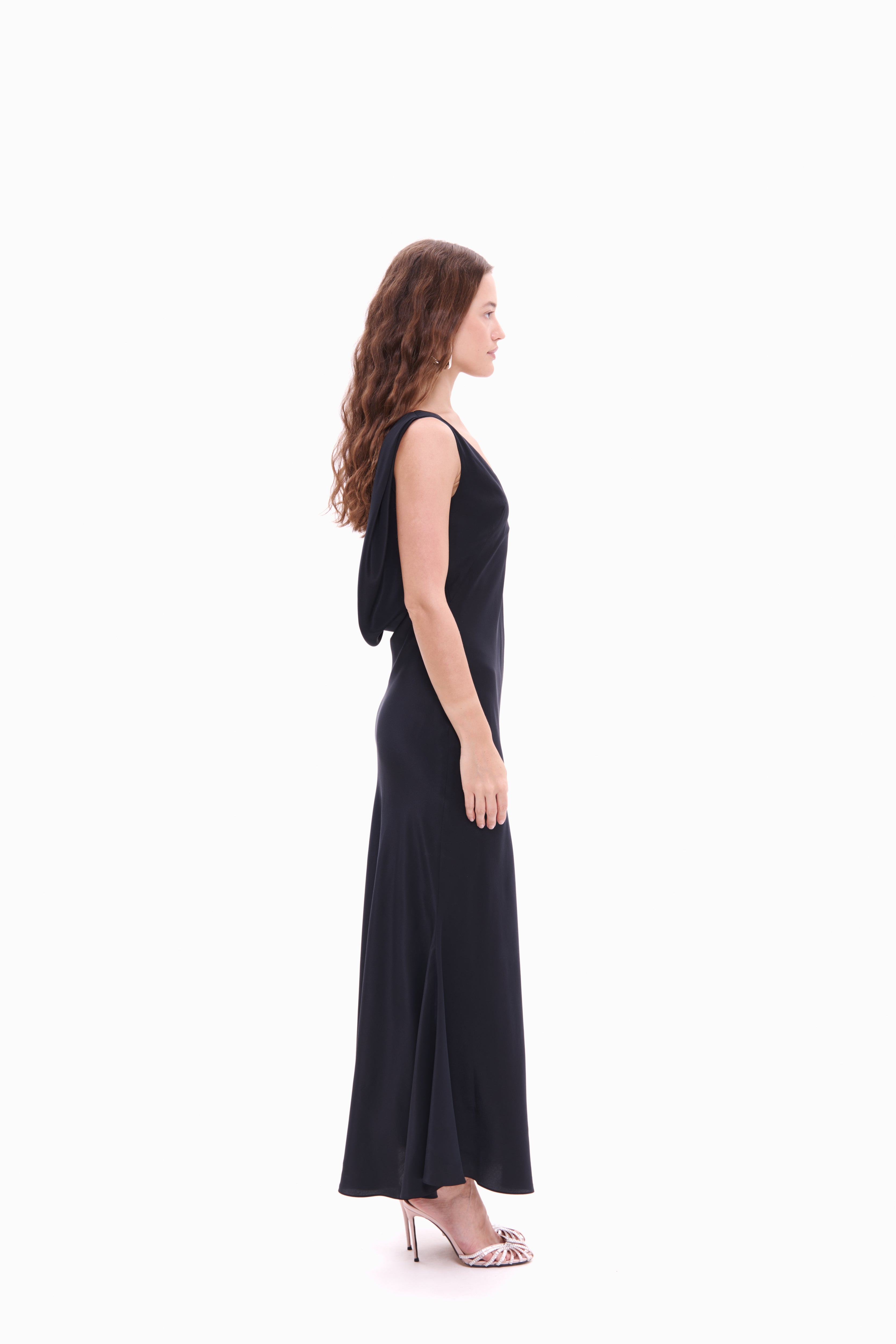 Woman wearing a black sleeveless dress on a white background