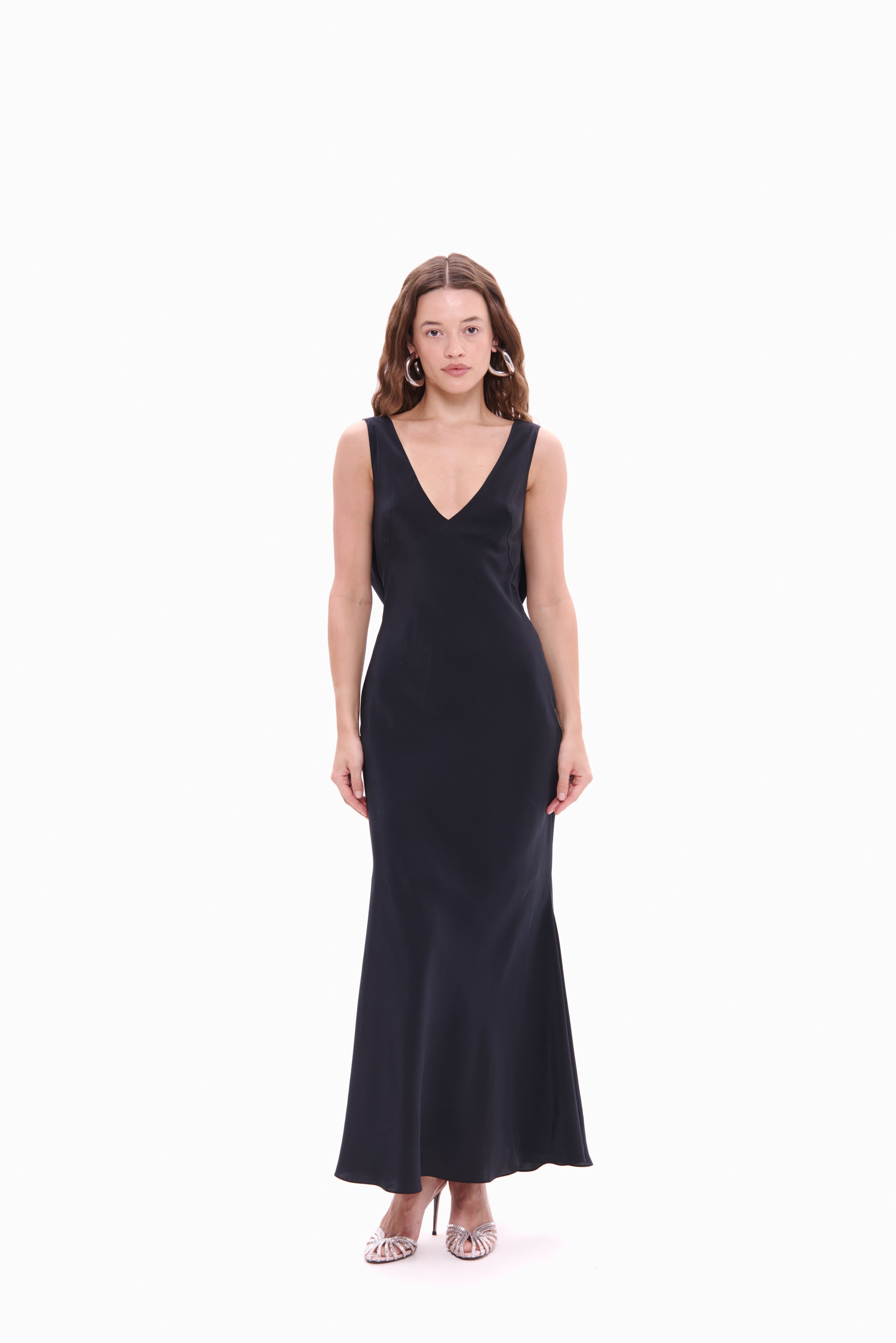 Woman wearing a black sleeveless dress on a white background