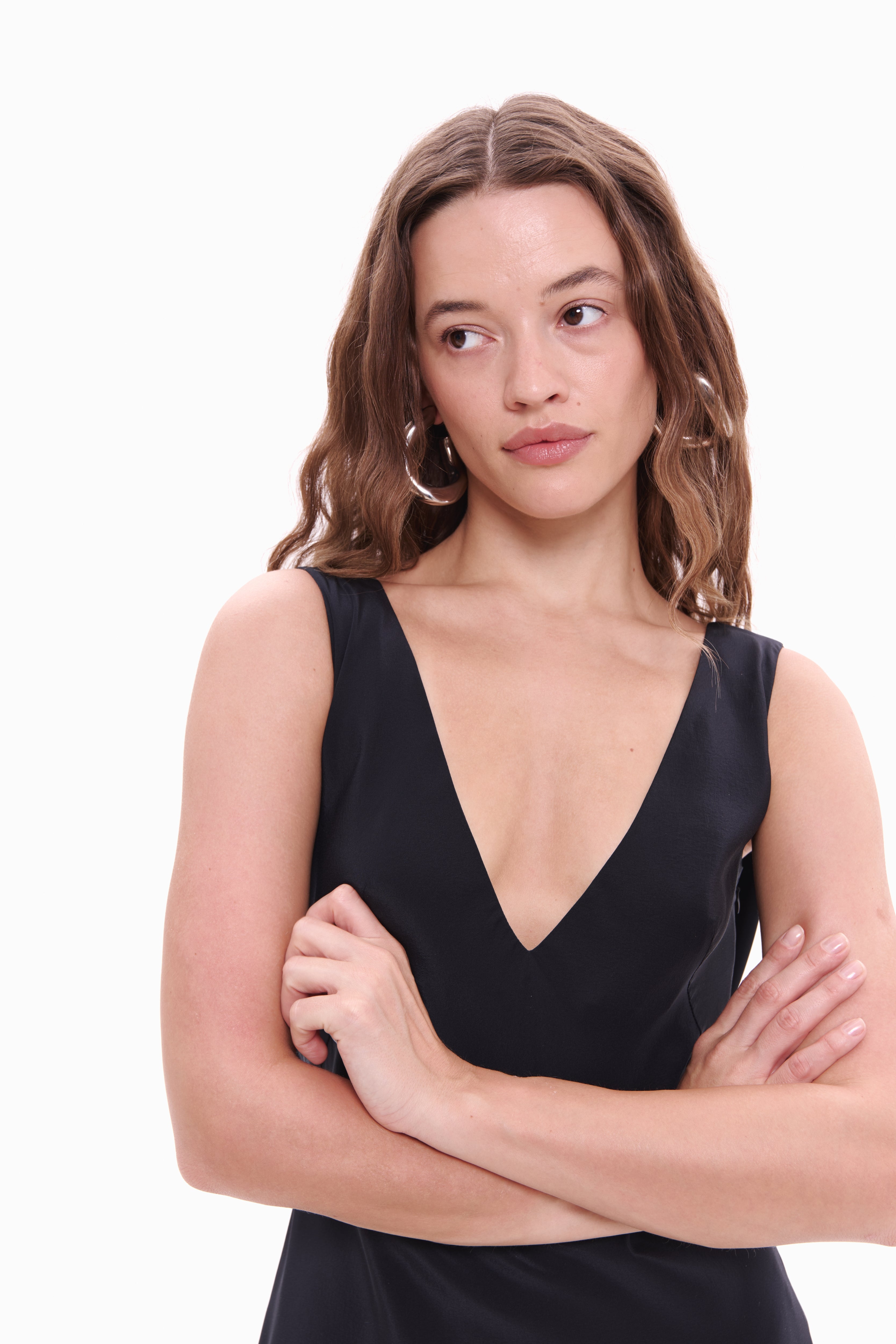 Woman wearing a black sleeveless top on a white background