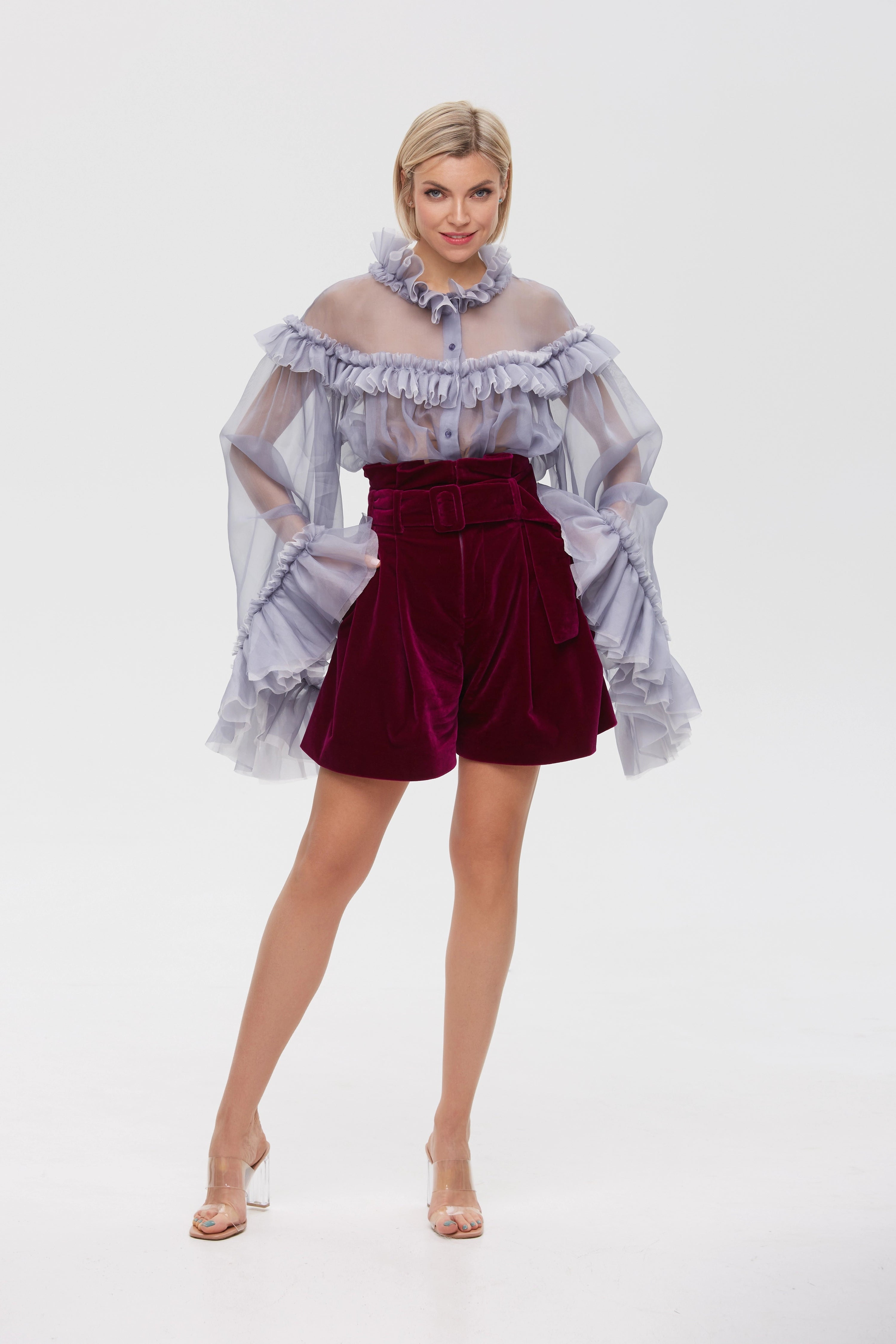 Woman wearing Burgundy Icon Shorts from Mimaussy Paris, full-length front view with off-shoulder ruffled top against a plain white studio background