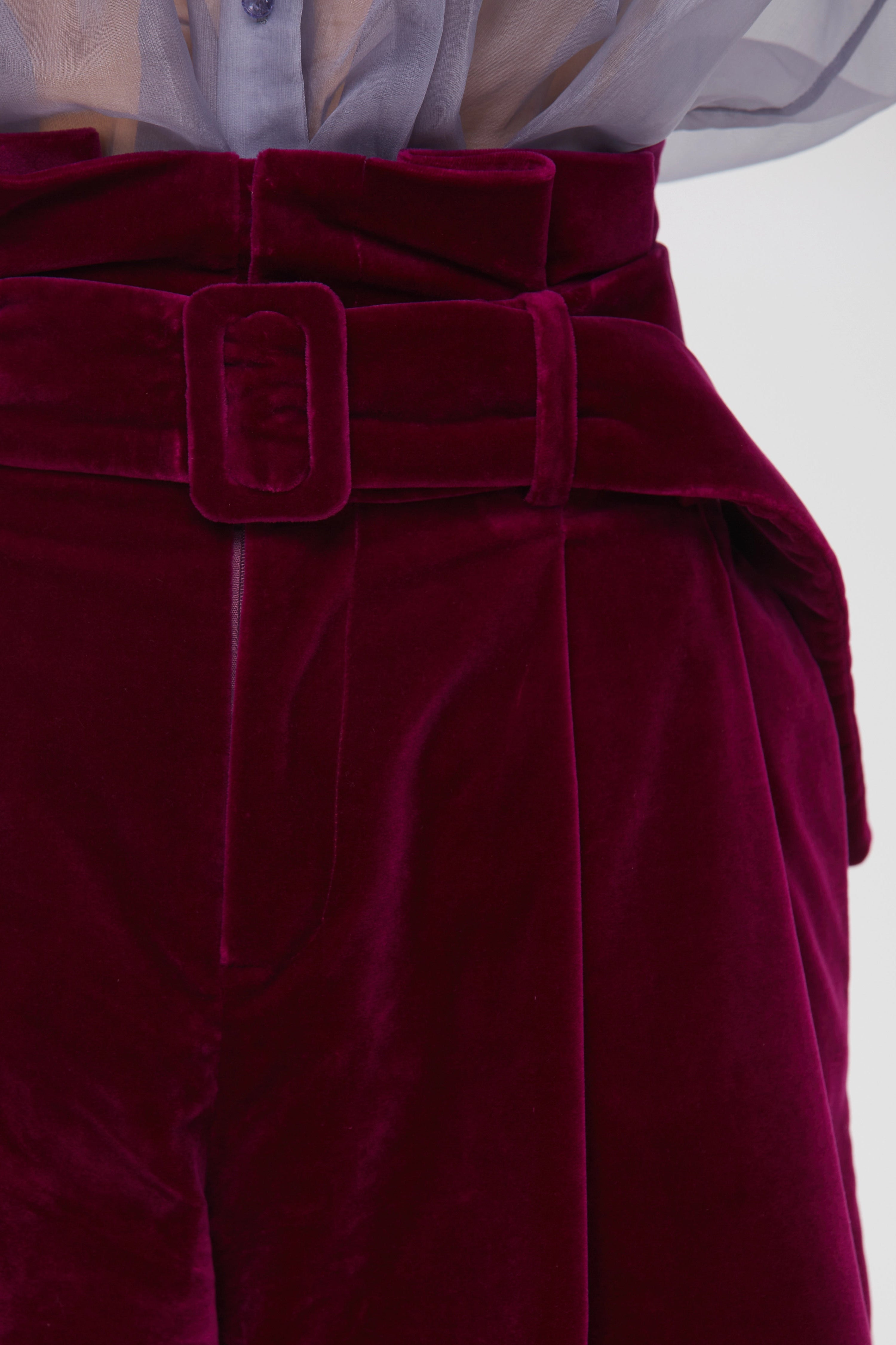 Woman wearing Burgundy Icon Shorts from Mimaussy Paris, studio close-up of front details against a plain white background