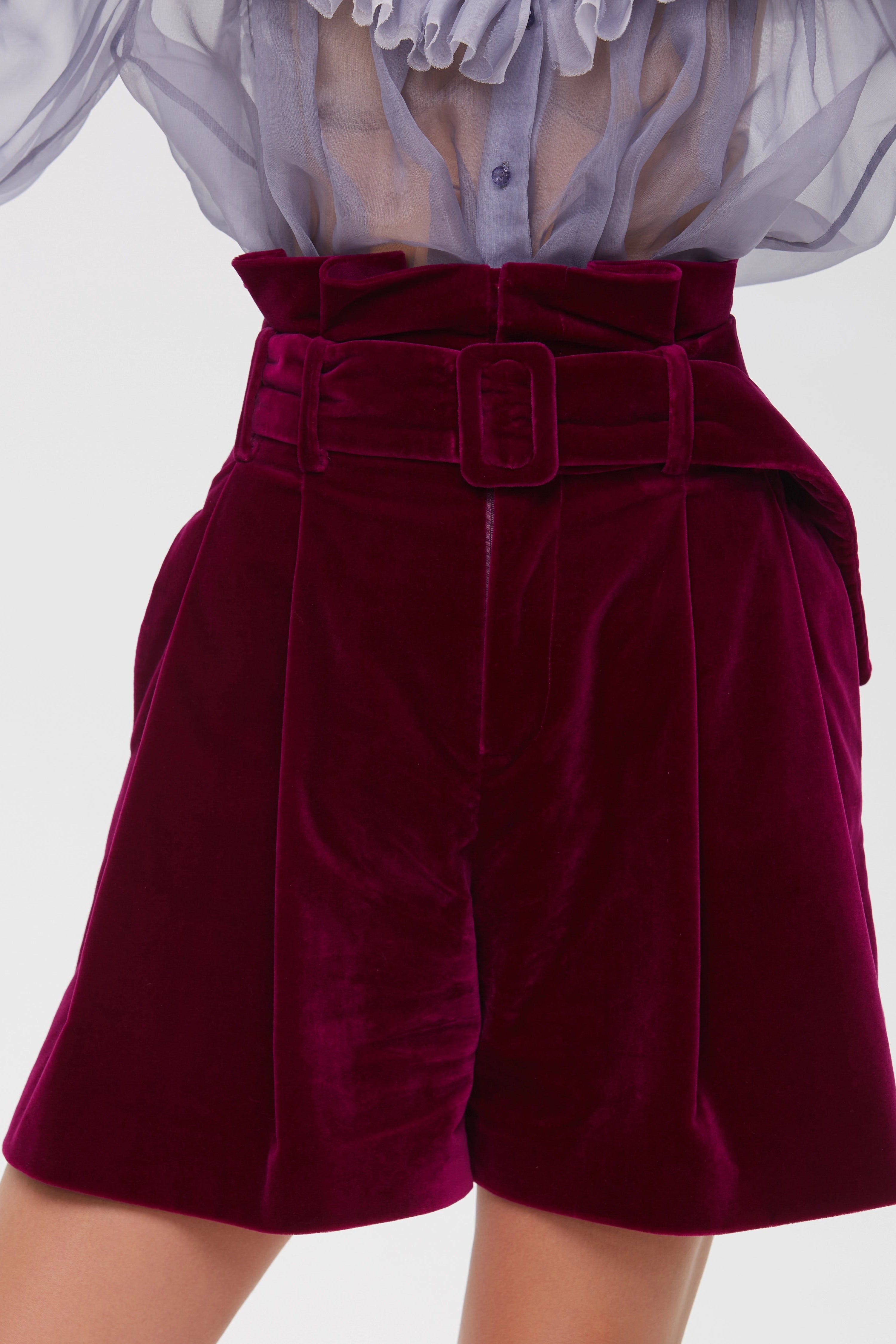 Woman wearing Burgundy Icon Shorts from Mimaussy Paris, studio close-up of front details against a plain white background