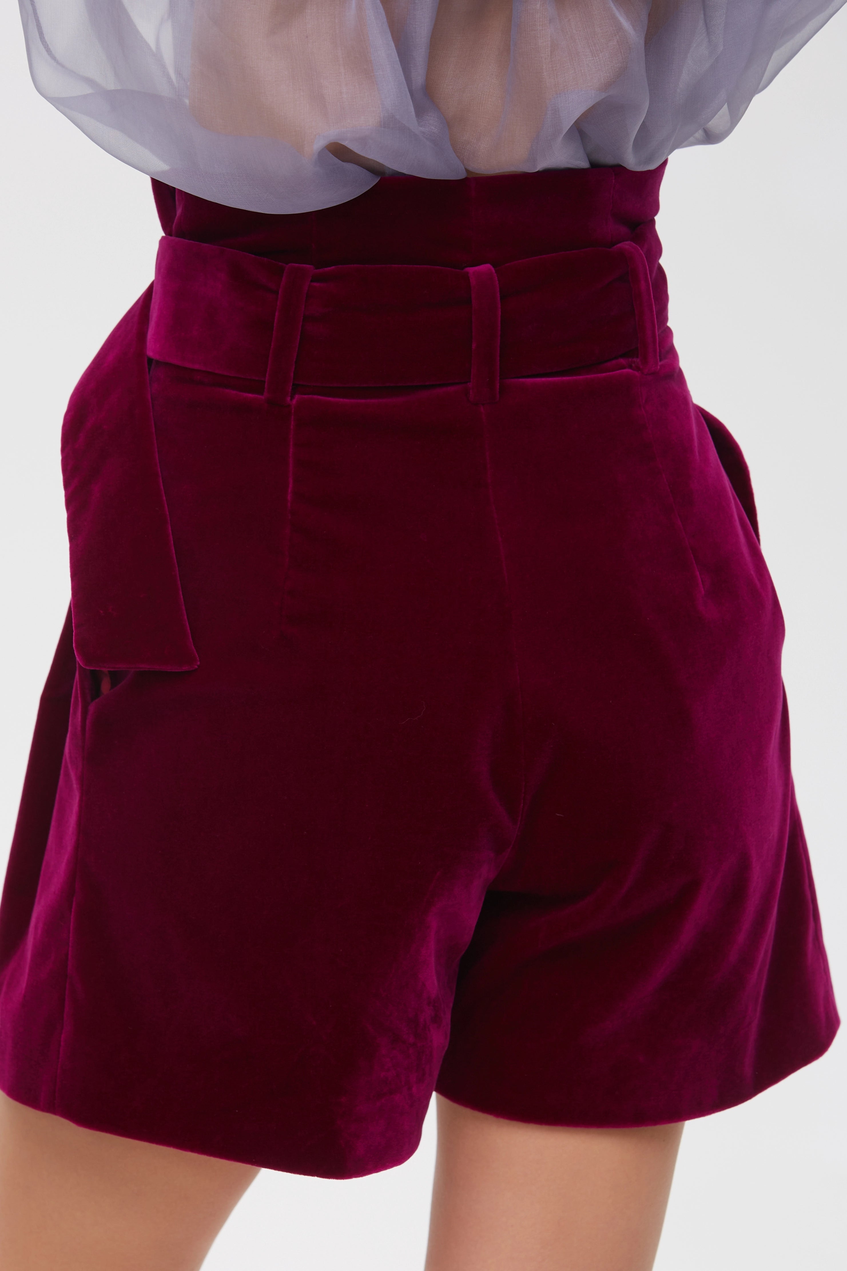 Woman wearing Burgundy Icon Shorts from Mimaussy Paris, back view studio close-up of rear details against a plain white background
