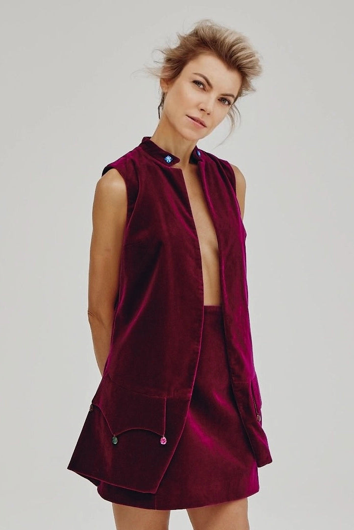Woman wearing Burgundy Icon Skirt from Mimaussy Paris, angled front view in studio setting against a plain white background