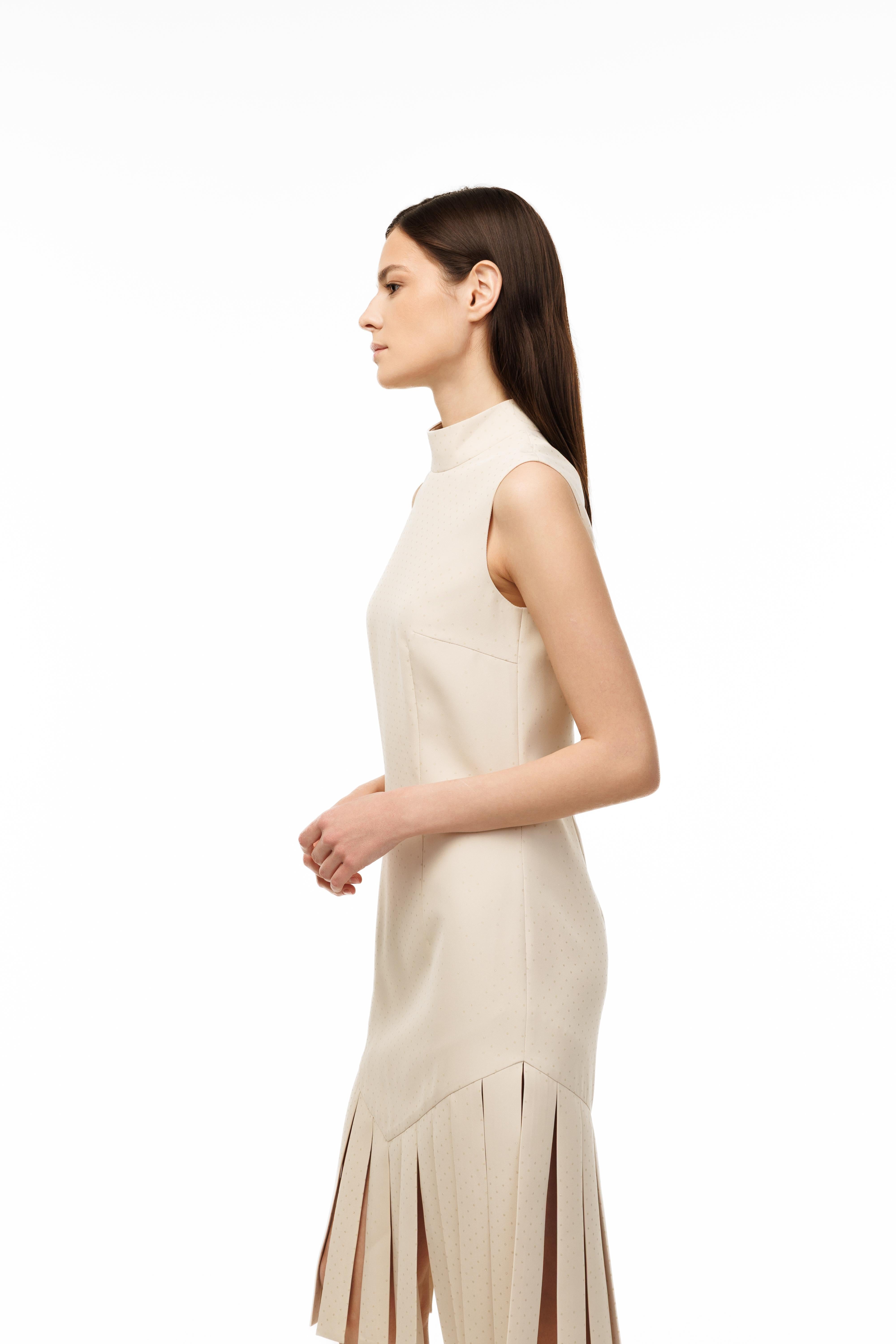 Woman wearing a beige sleeveless dress on a white background