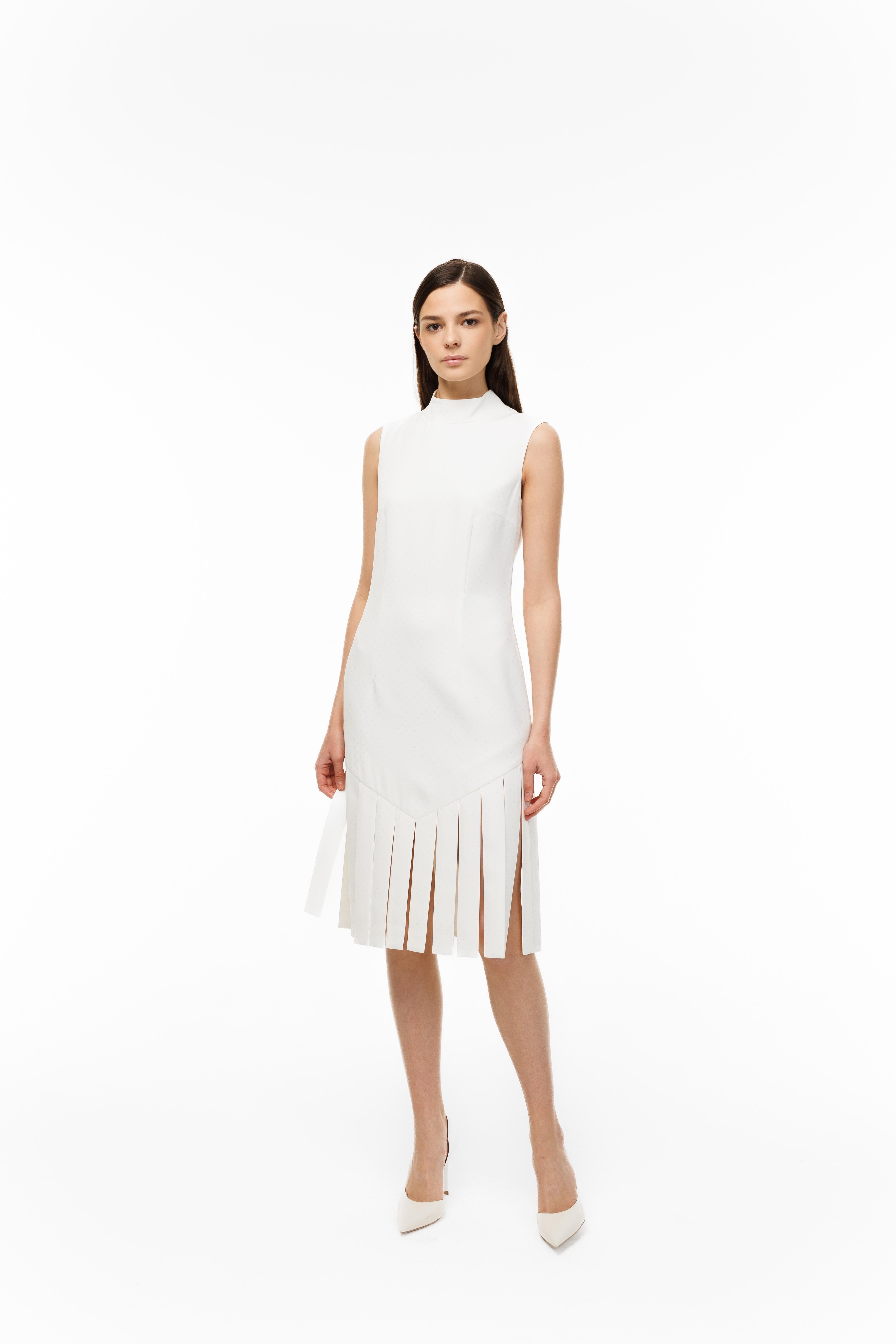 Woman wearing a white dress with pleated skirt on a white background