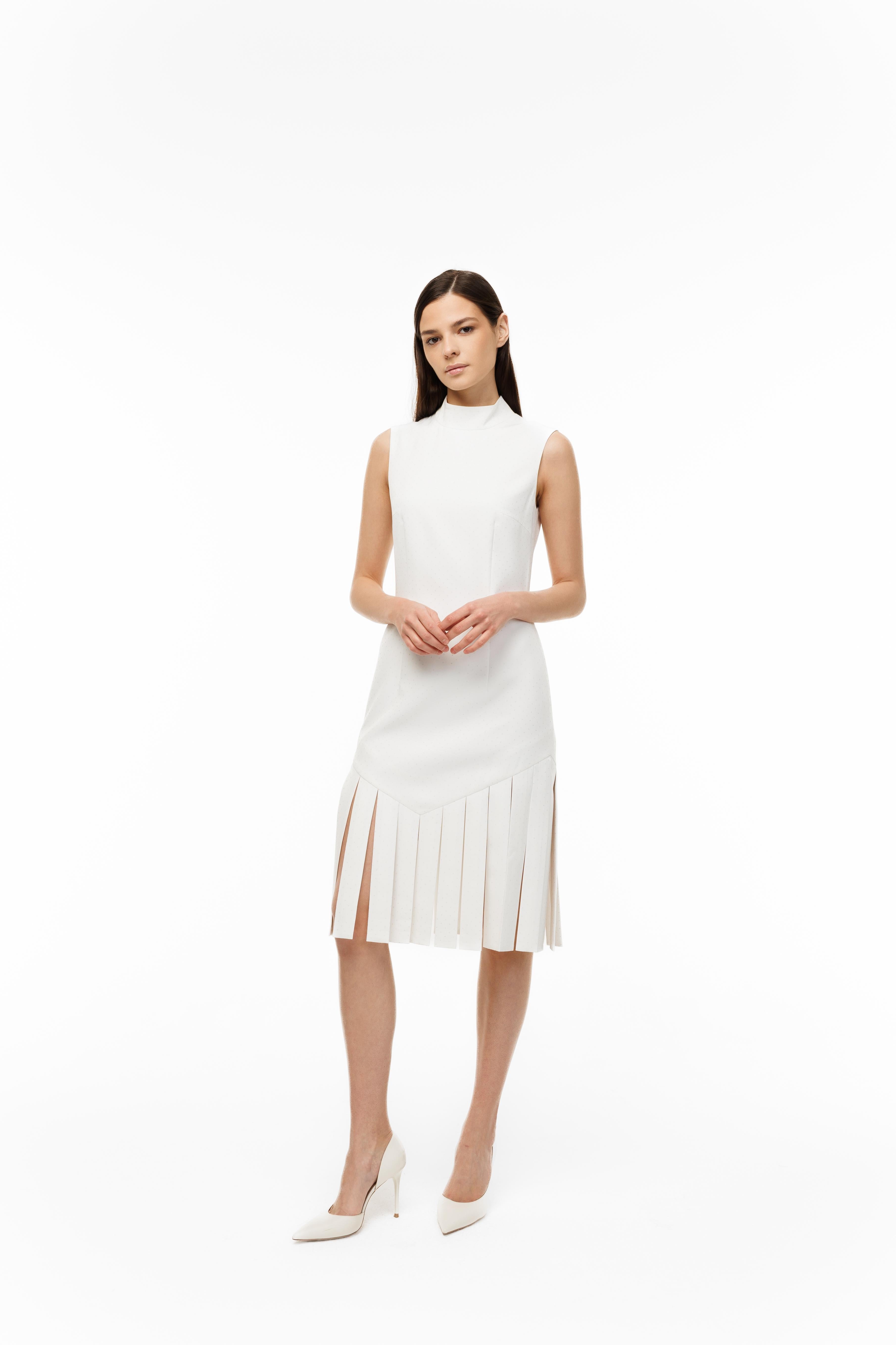 Woman wearing a white dress with pleated skirt on a white background