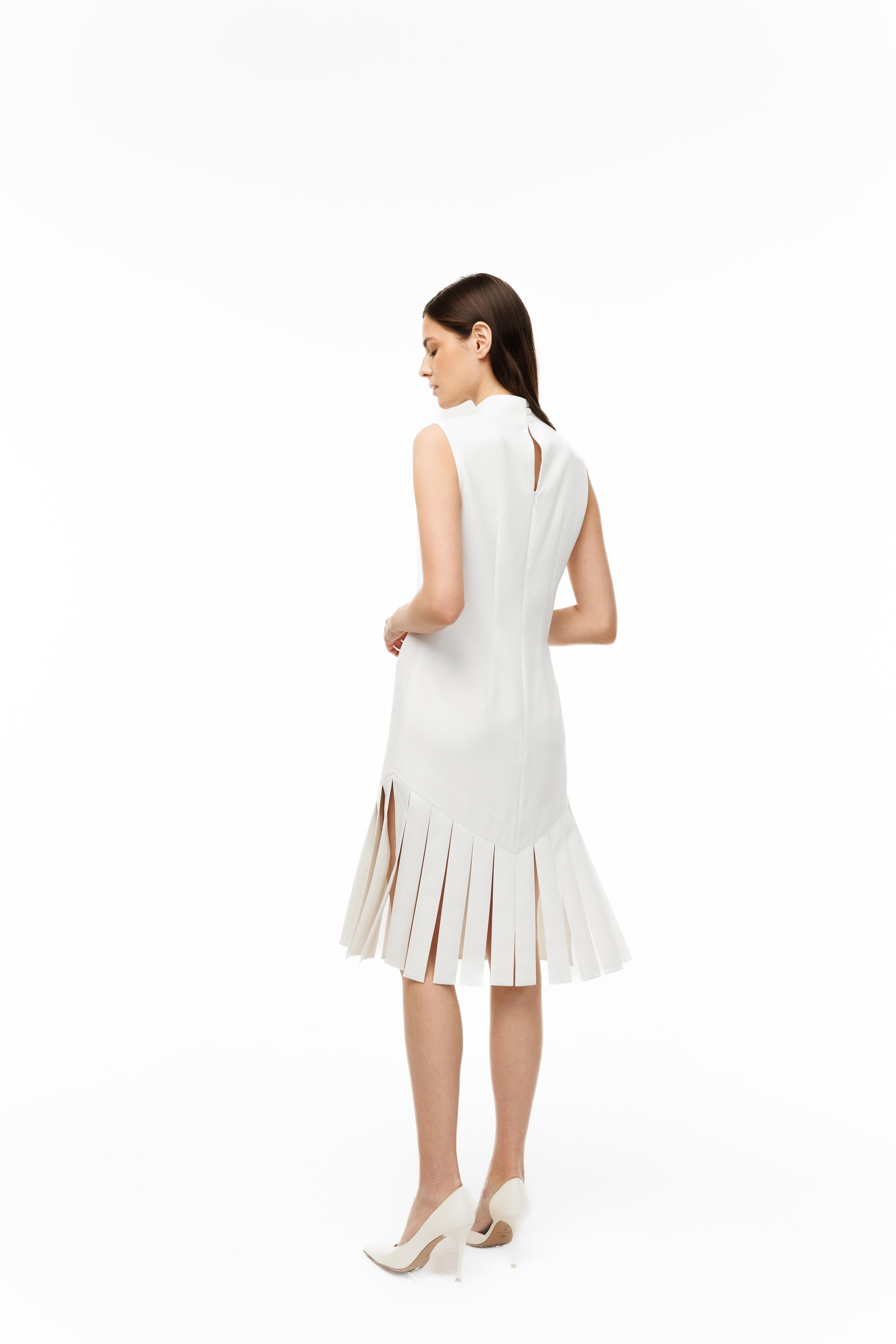 Woman wearing a white dress with a pleated skirt on a white background
