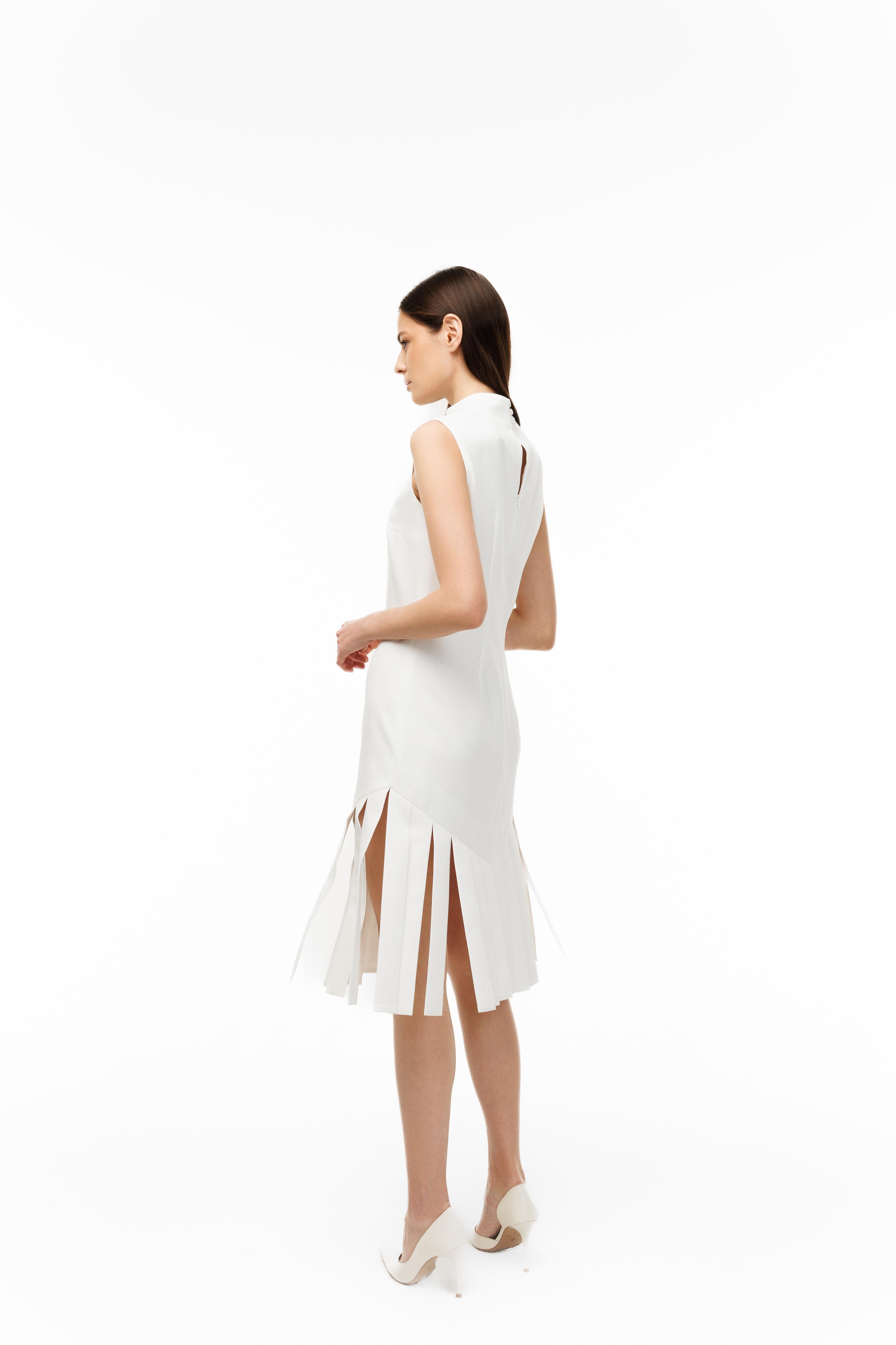 Woman wearing a white dress with a slit on a white background