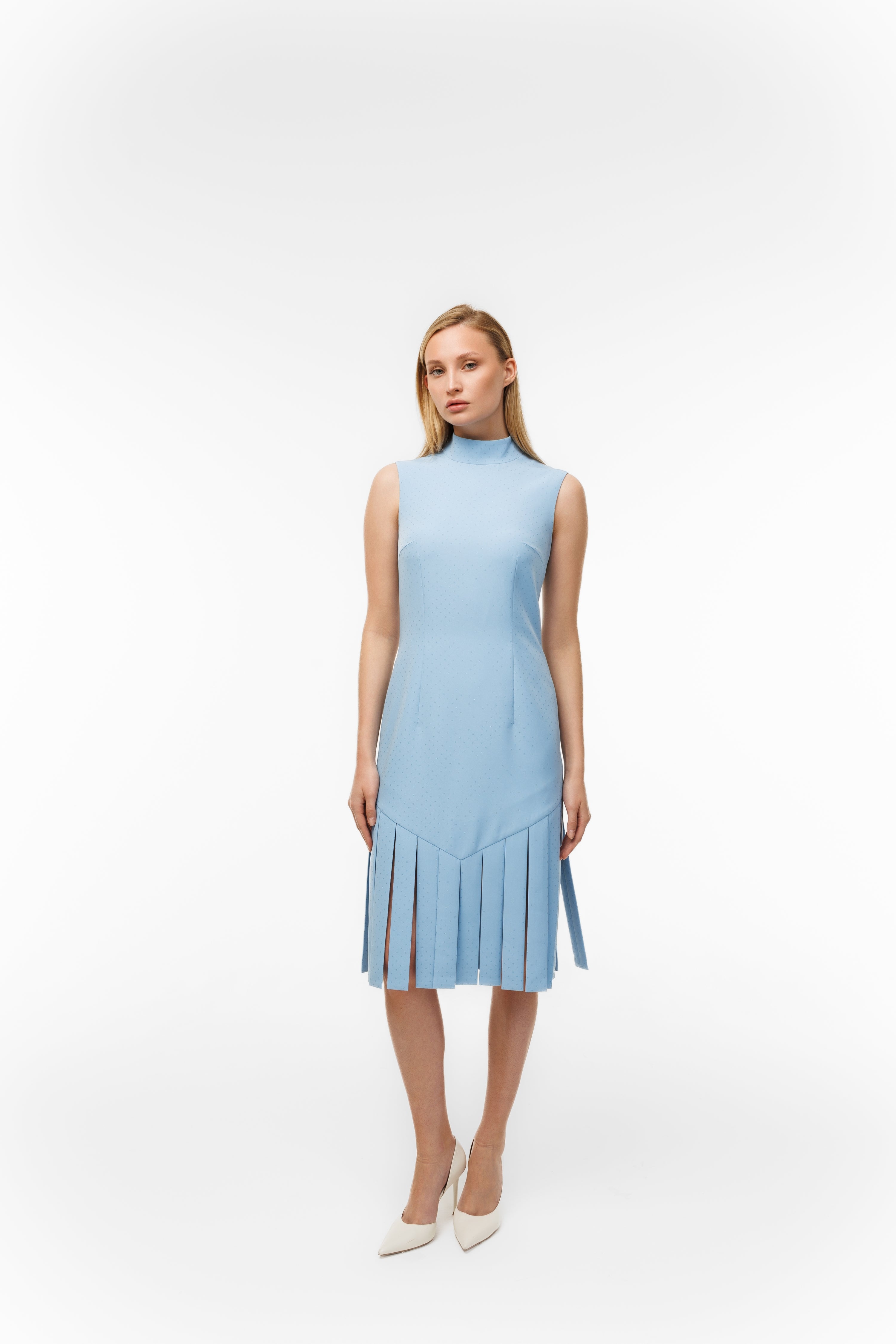 Woman wearing Charlestone Sky Blue from Mimaussy Paris, light blue dress on white background, studio setting