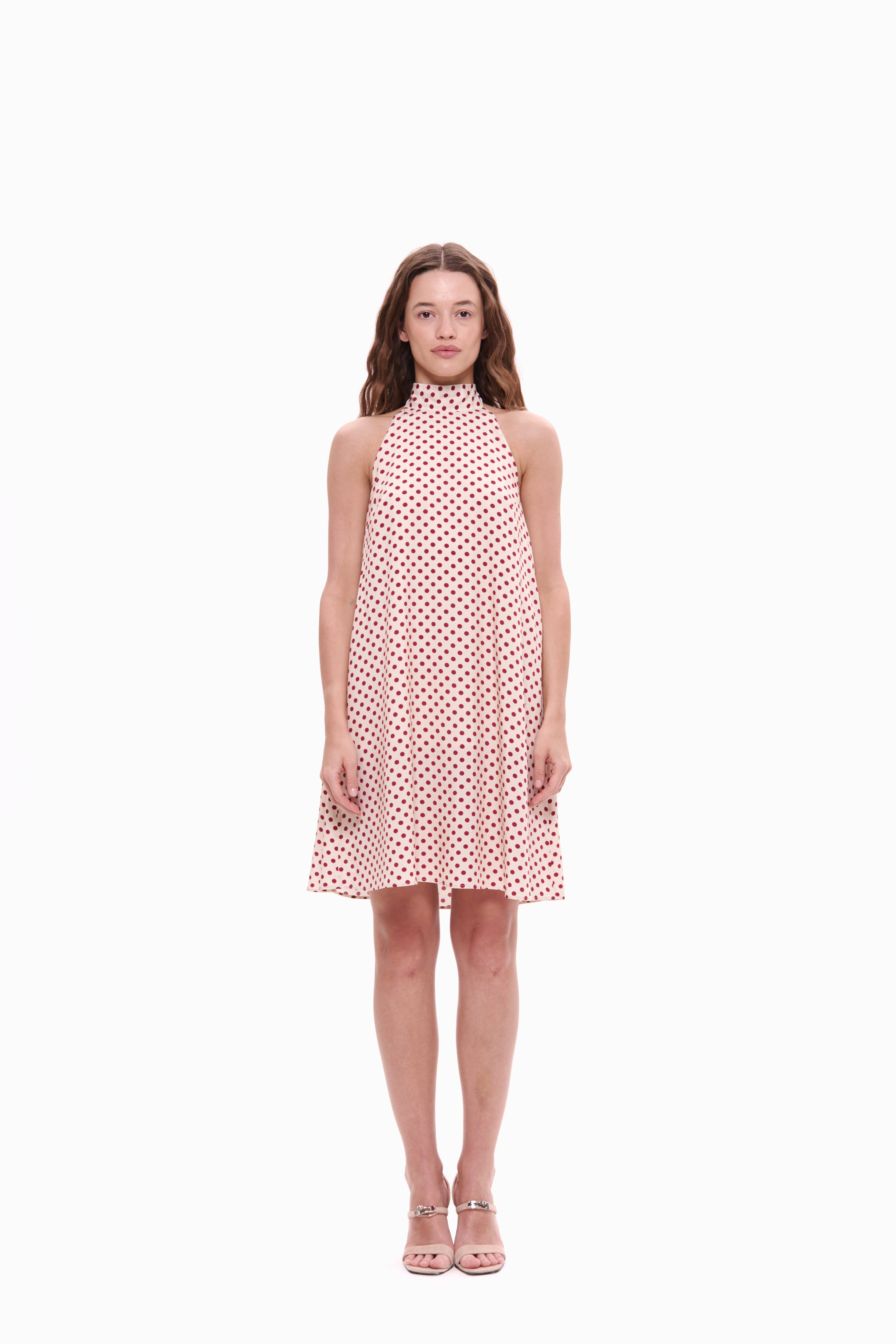 Woman wearing a polka dot dress on a white background