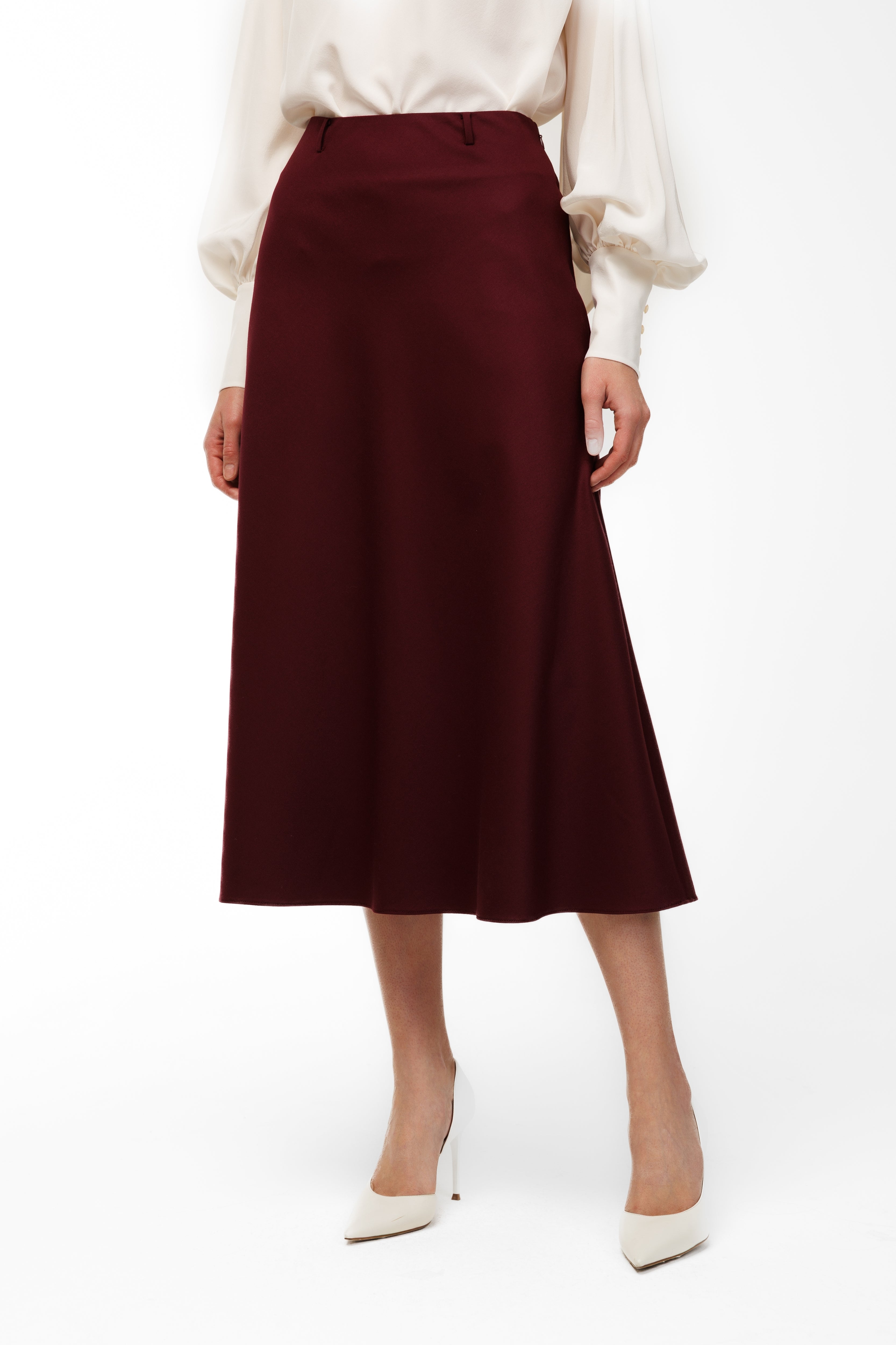 Maroon skirt worn by a person on a white background