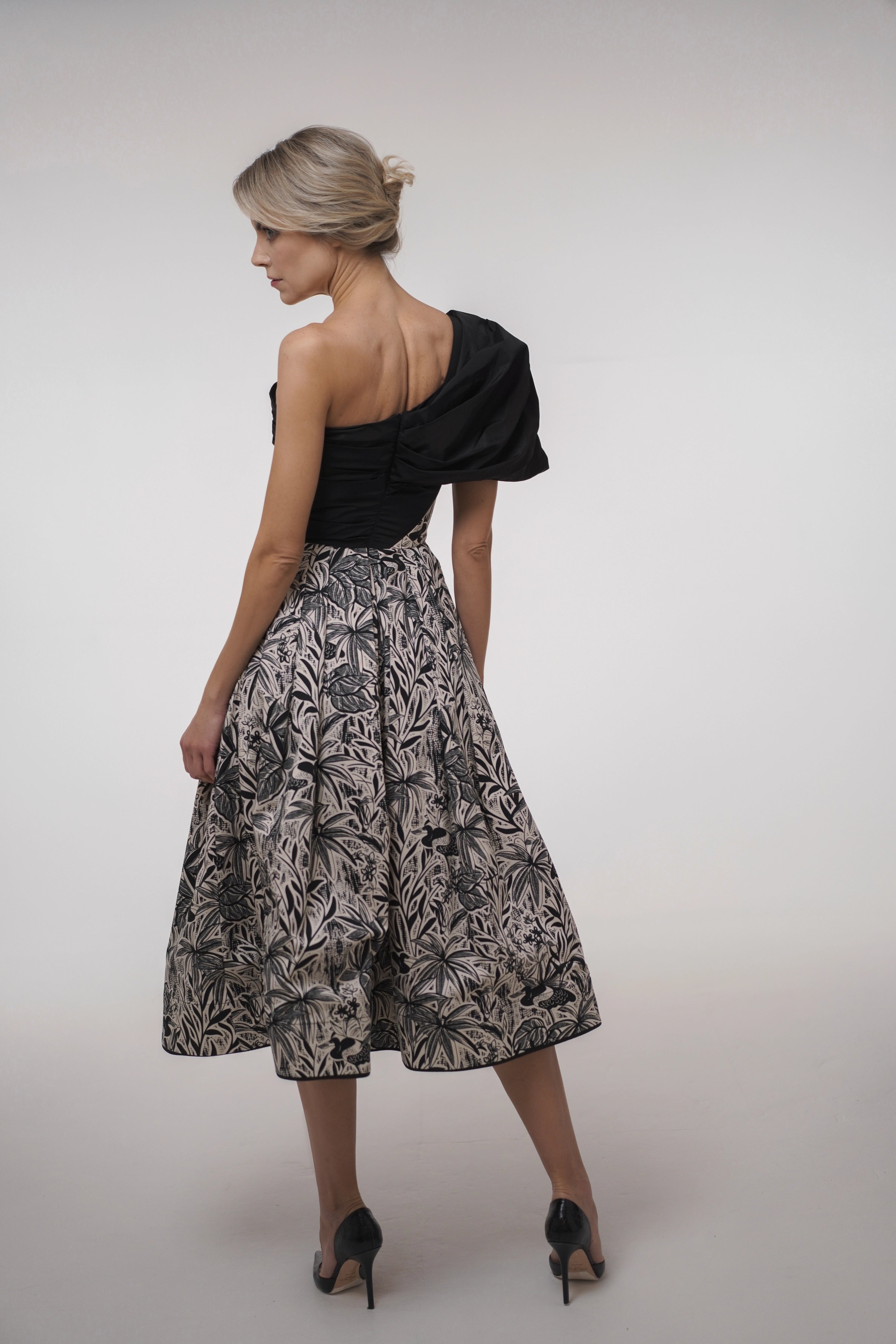 Woman wearing La Muse Nocturne Dress from Mimaussy Paris, back view in studio setting against a plain white background