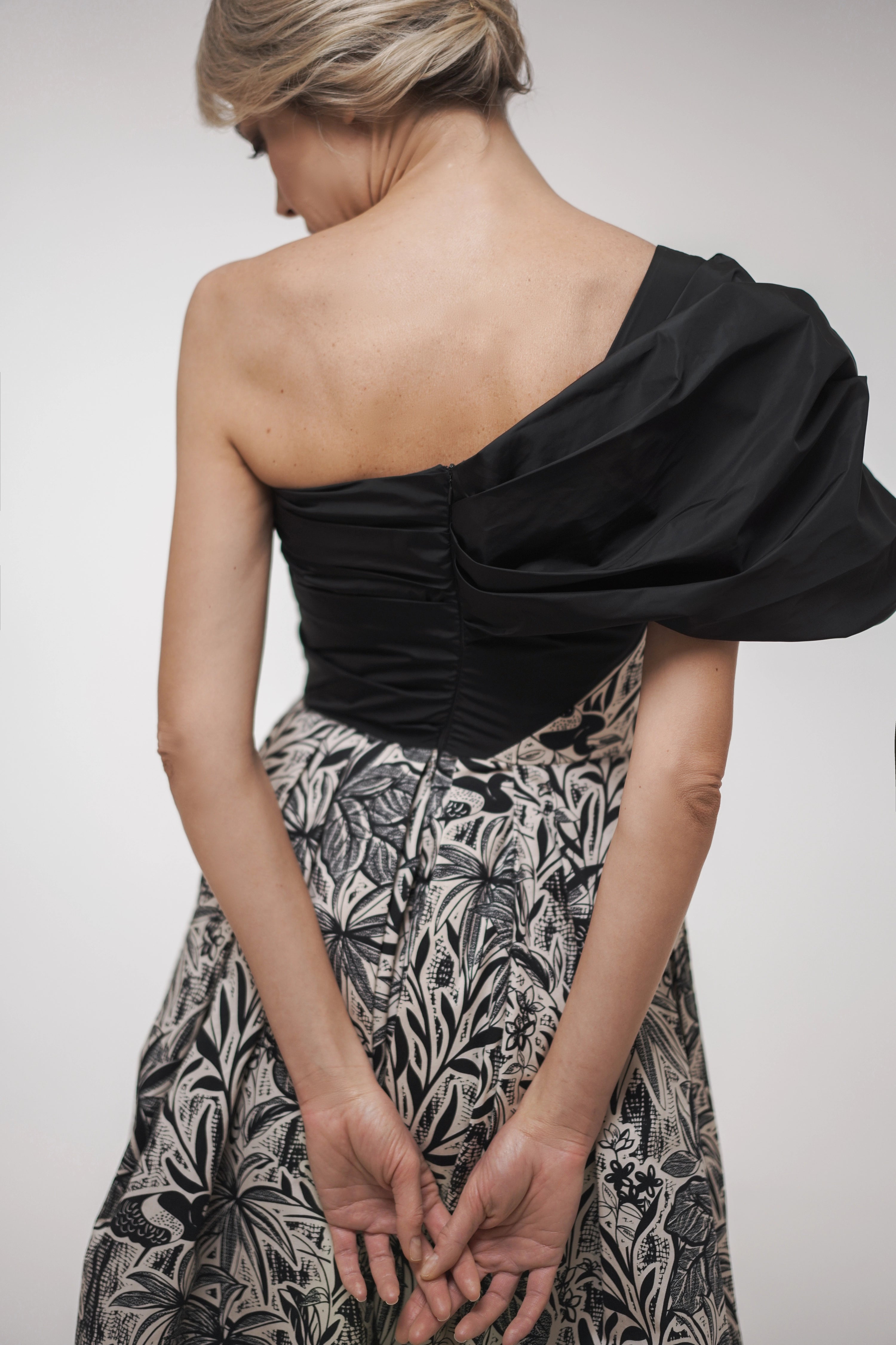 Woman wearing La Muse Nocturne Dress from Mimaussy Paris, studio close-up of back details against a plain white background