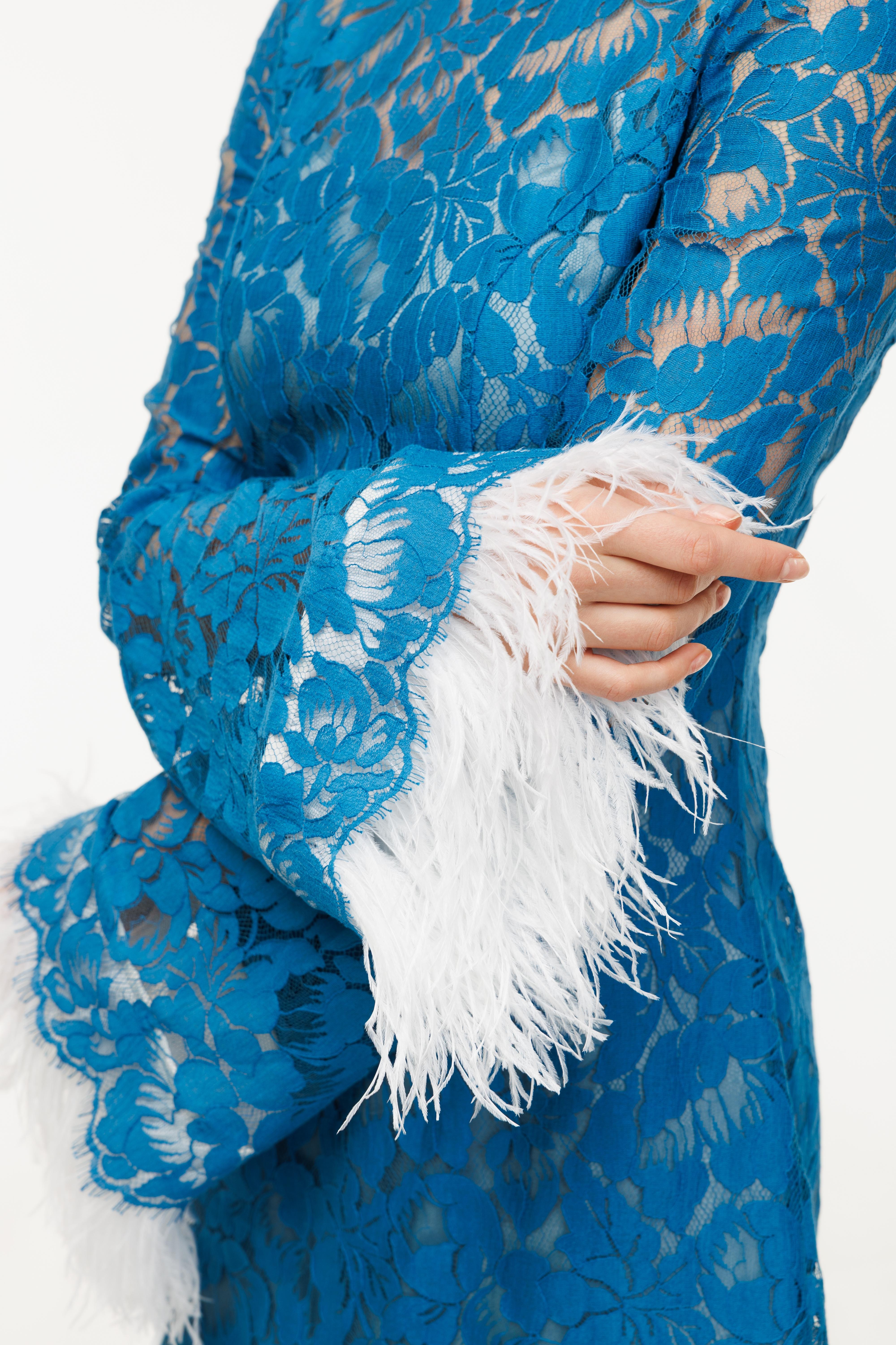 Blue floral-patterned garment with white feathered cuffs on a white background