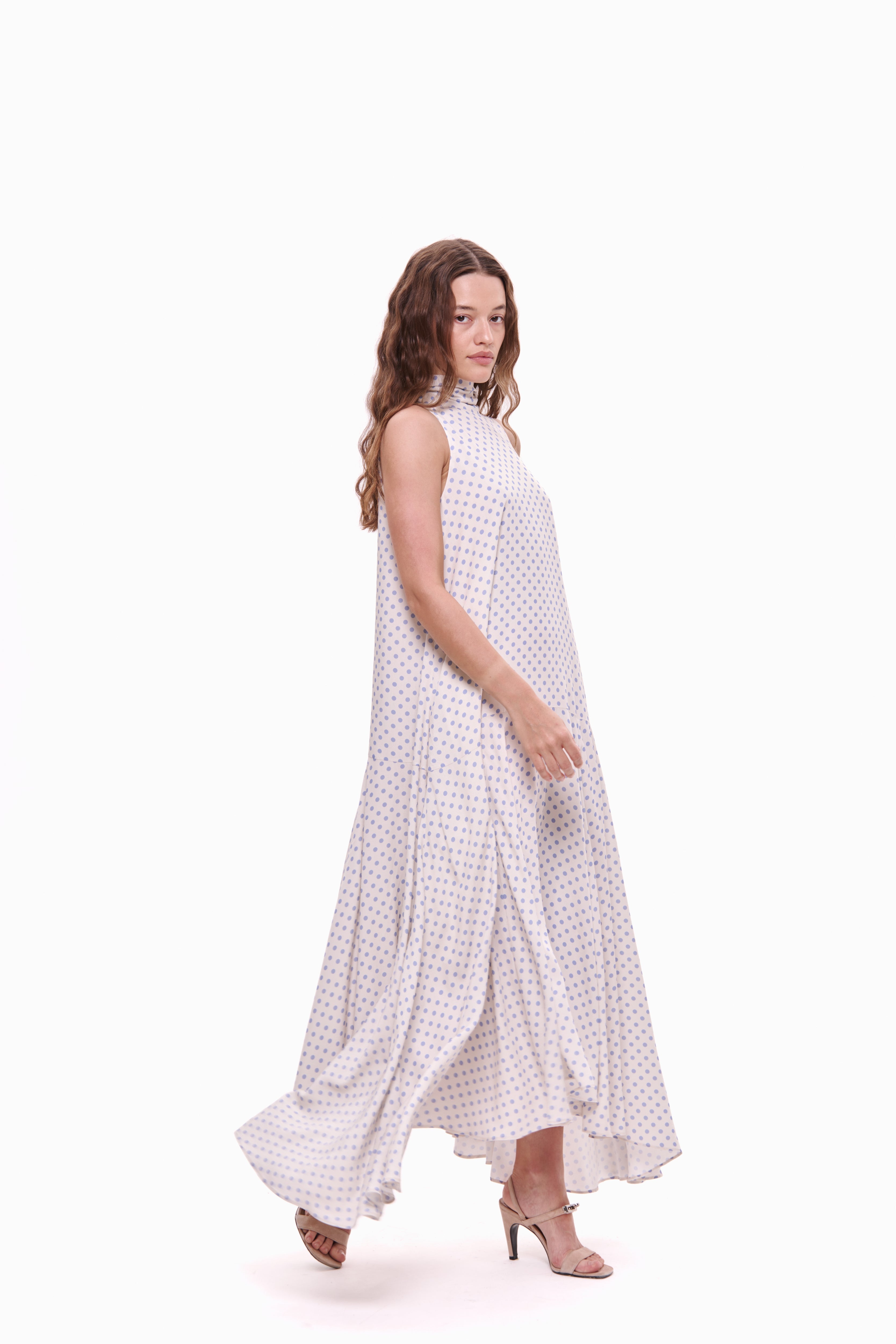 Woman wearing a white checkered dress on a white background