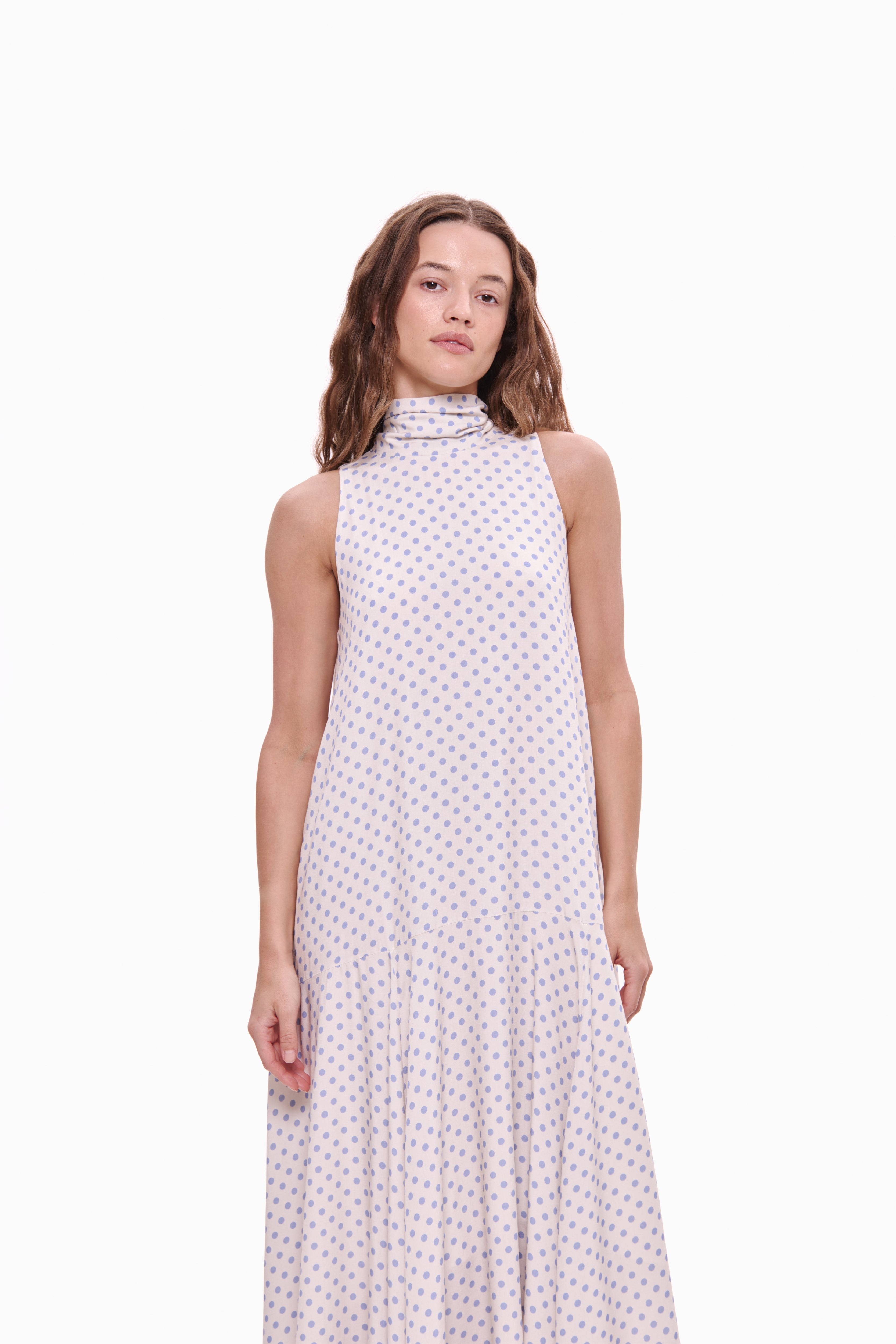 Woman wearing a sleeveless dress with a white background