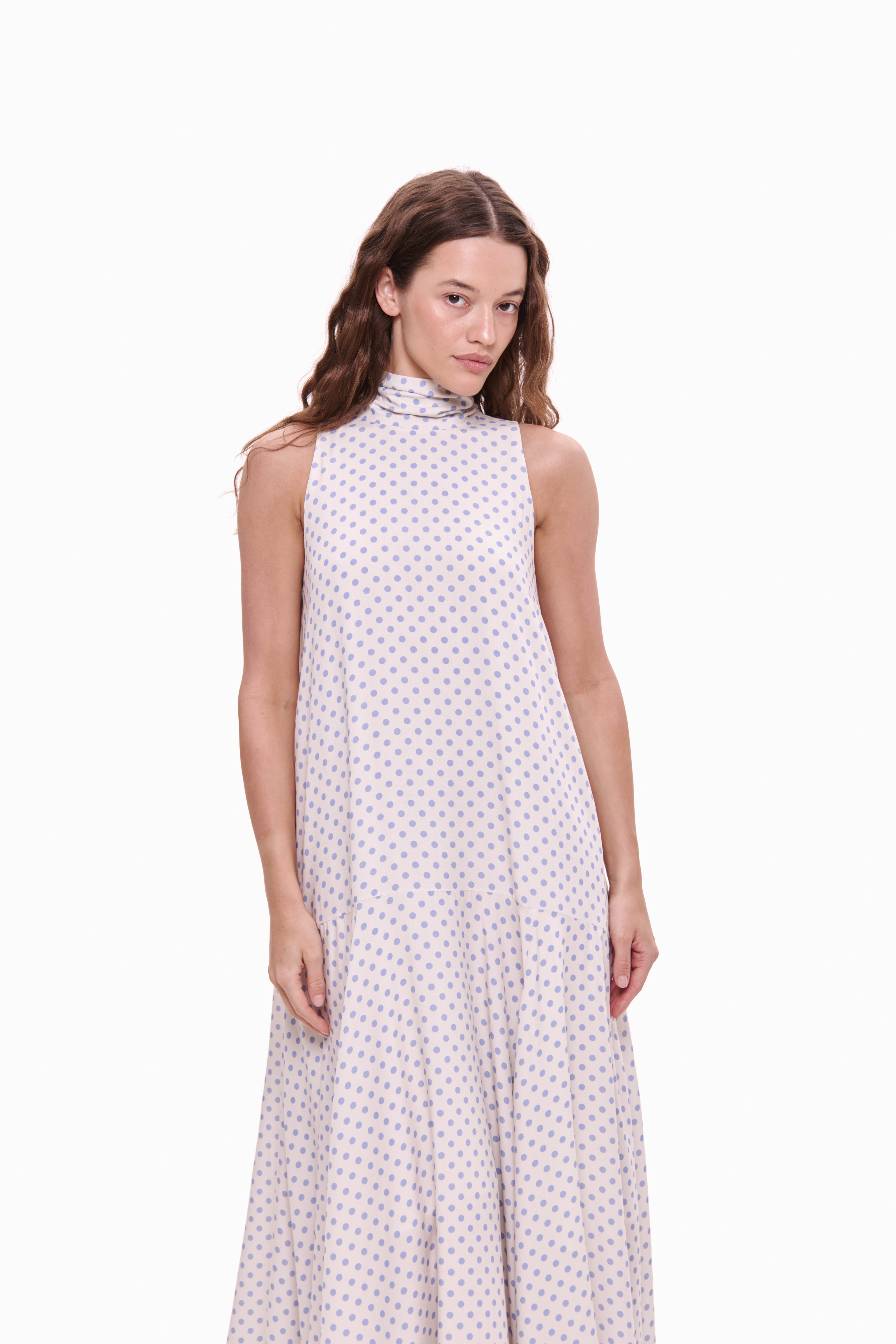 Woman wearing a sleeveless dress with a white background
