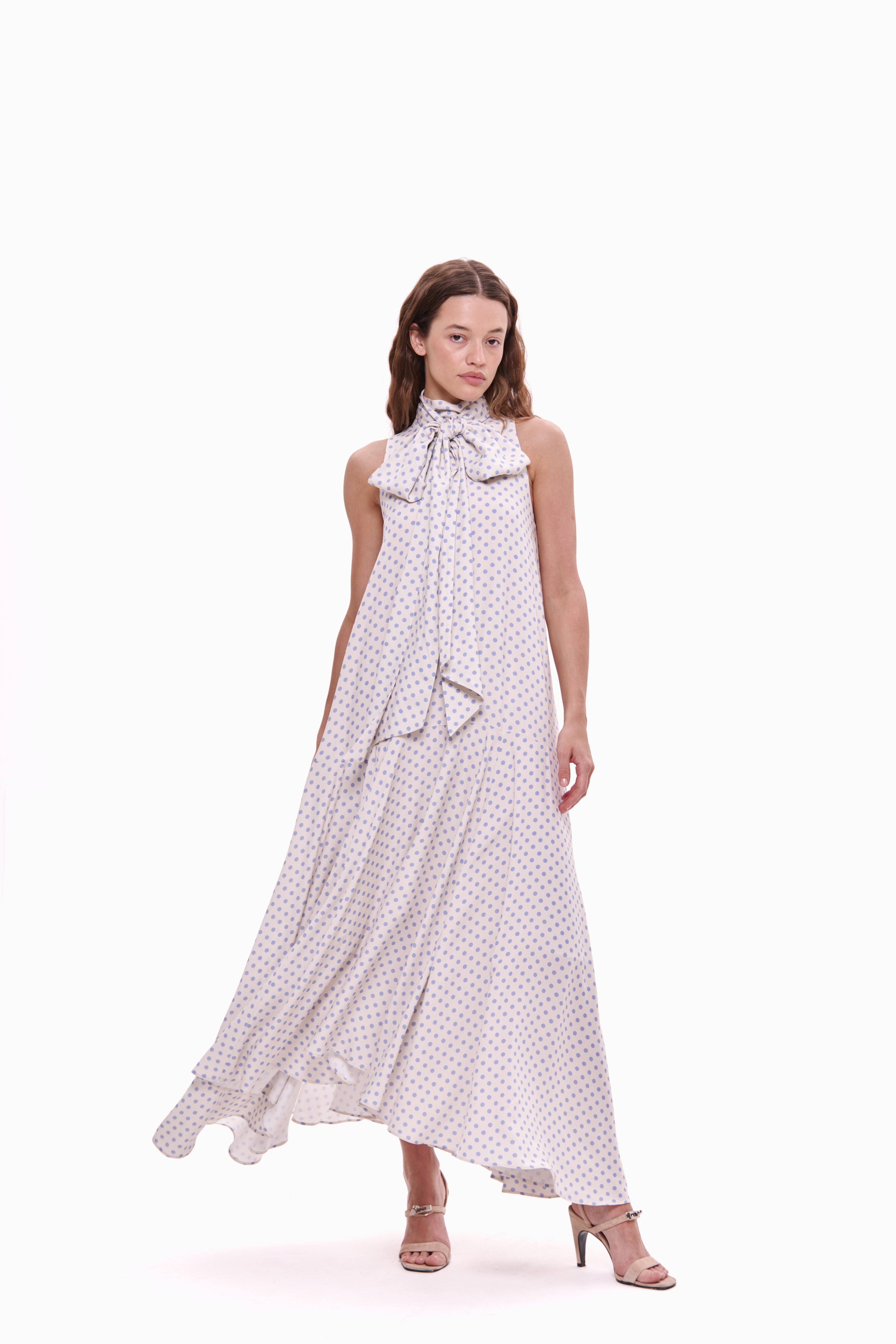 Woman wearing a white dress with a pattern on a white background