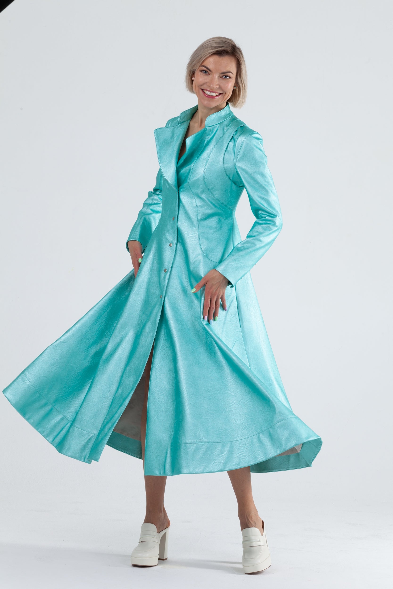 Woman wearing Matrix Coat from Mimaussy Paris in Tiffany Blue, front view against a plain white studio background