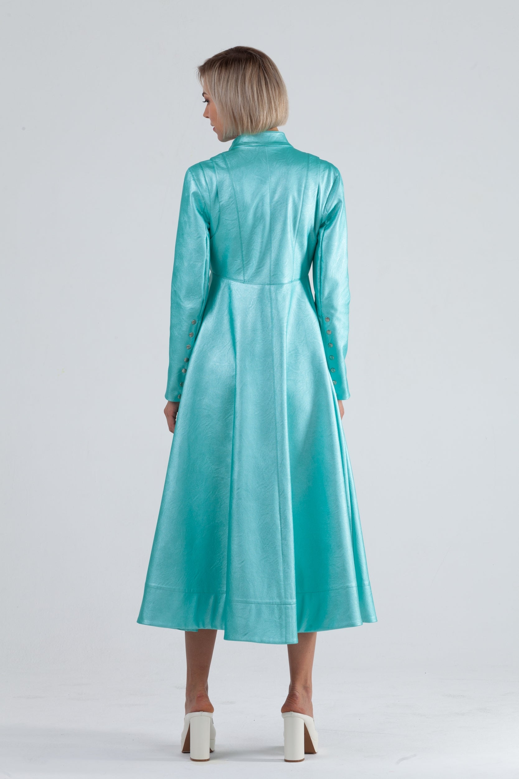 Woman wearing Matrix Coat from Mimaussy Paris in Tiffany Blue, back view full-length shot in studio setting against a plain white background