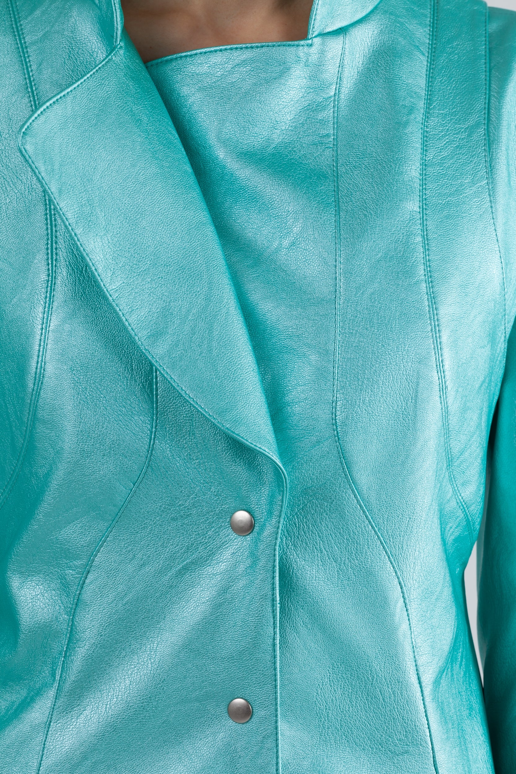 Woman wearing Matrix Coat from Mimaussy Paris in Tiffany Blue, studio close-up of chest area