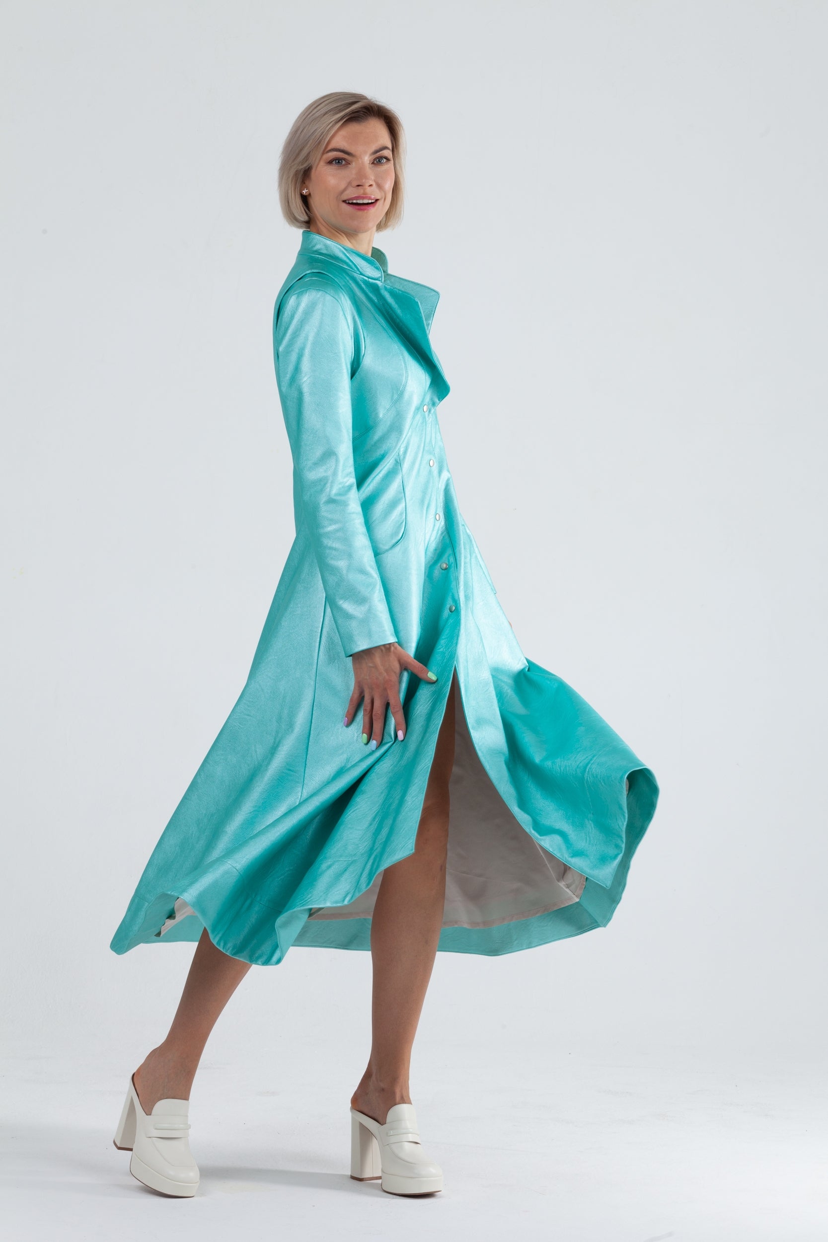 Woman wearing Matrix Coat from Mimaussy Paris in Tiffany Blue, front view against a plain white studio background