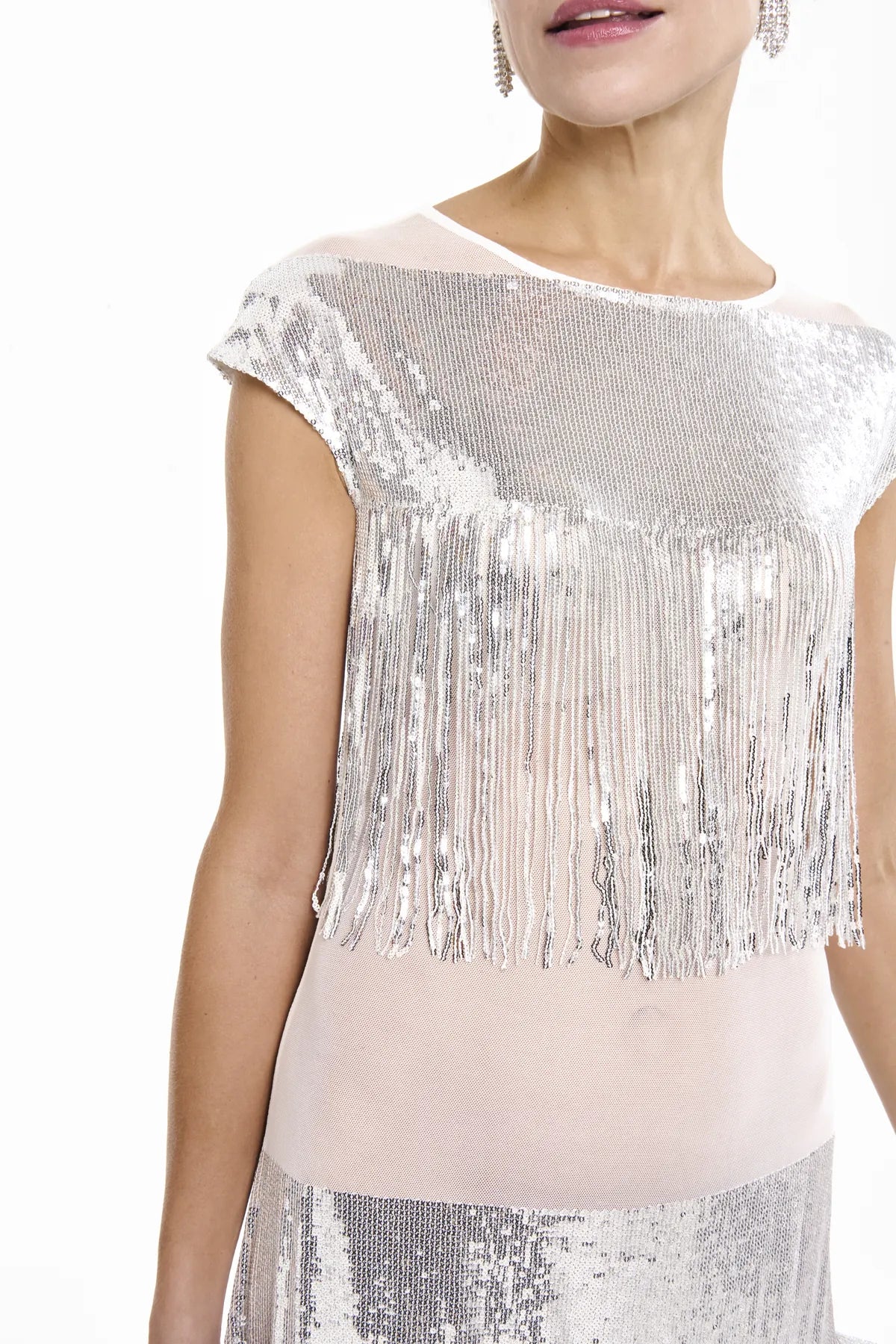 Close-up of a woman in a silver sequin fringe dress, the Midnight Charleston Dress from Mimaussy Paris, posing elegantly.