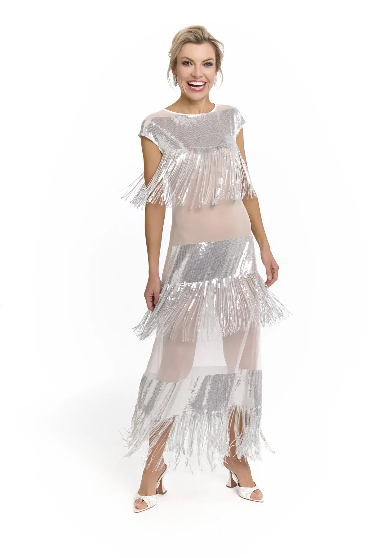 A woman wearing a silver fringed dress, the Midnight Charleston Dress by Mimaussy Paris, exuding glamour and grace.