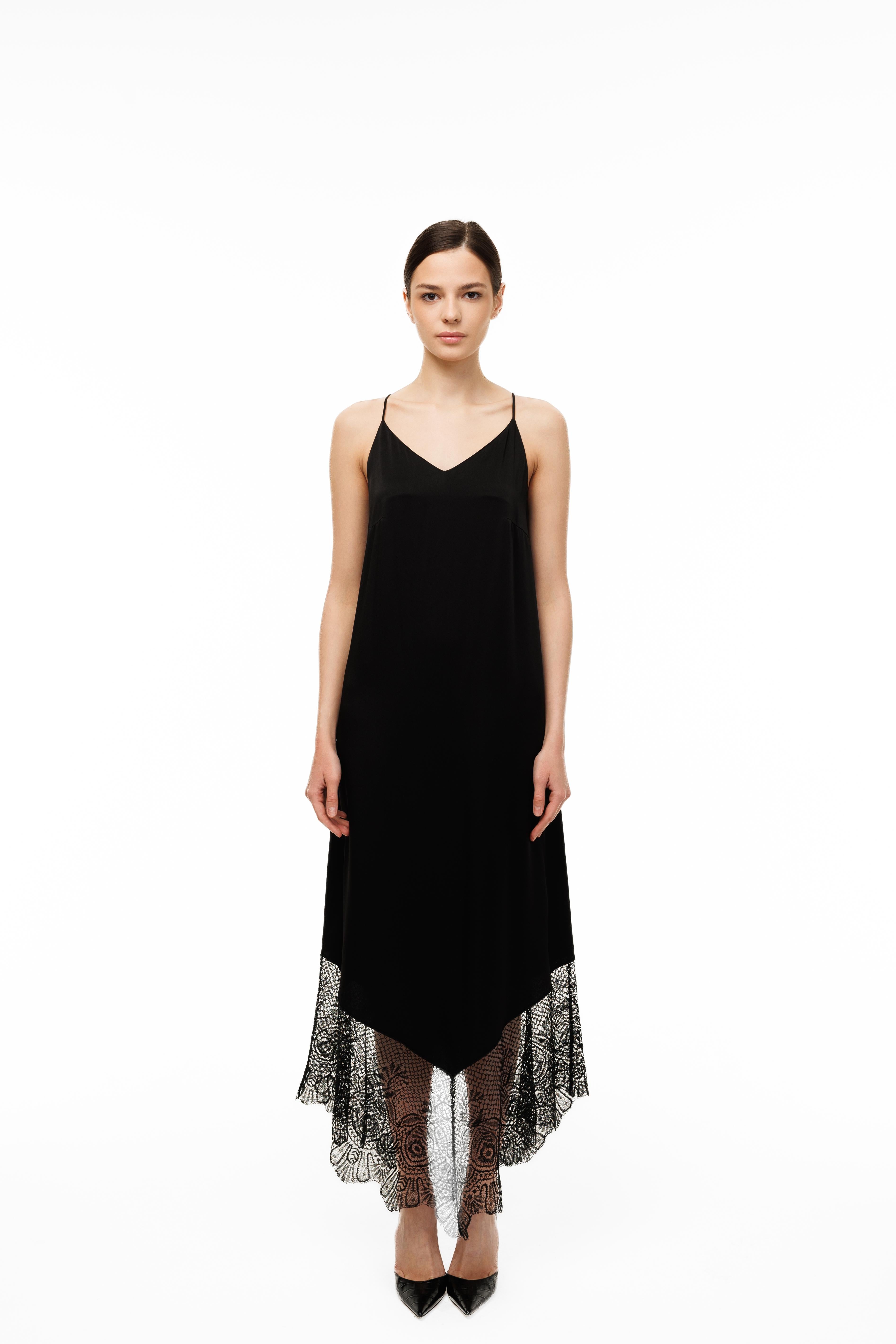 Black slip dress with lace hem on a white background