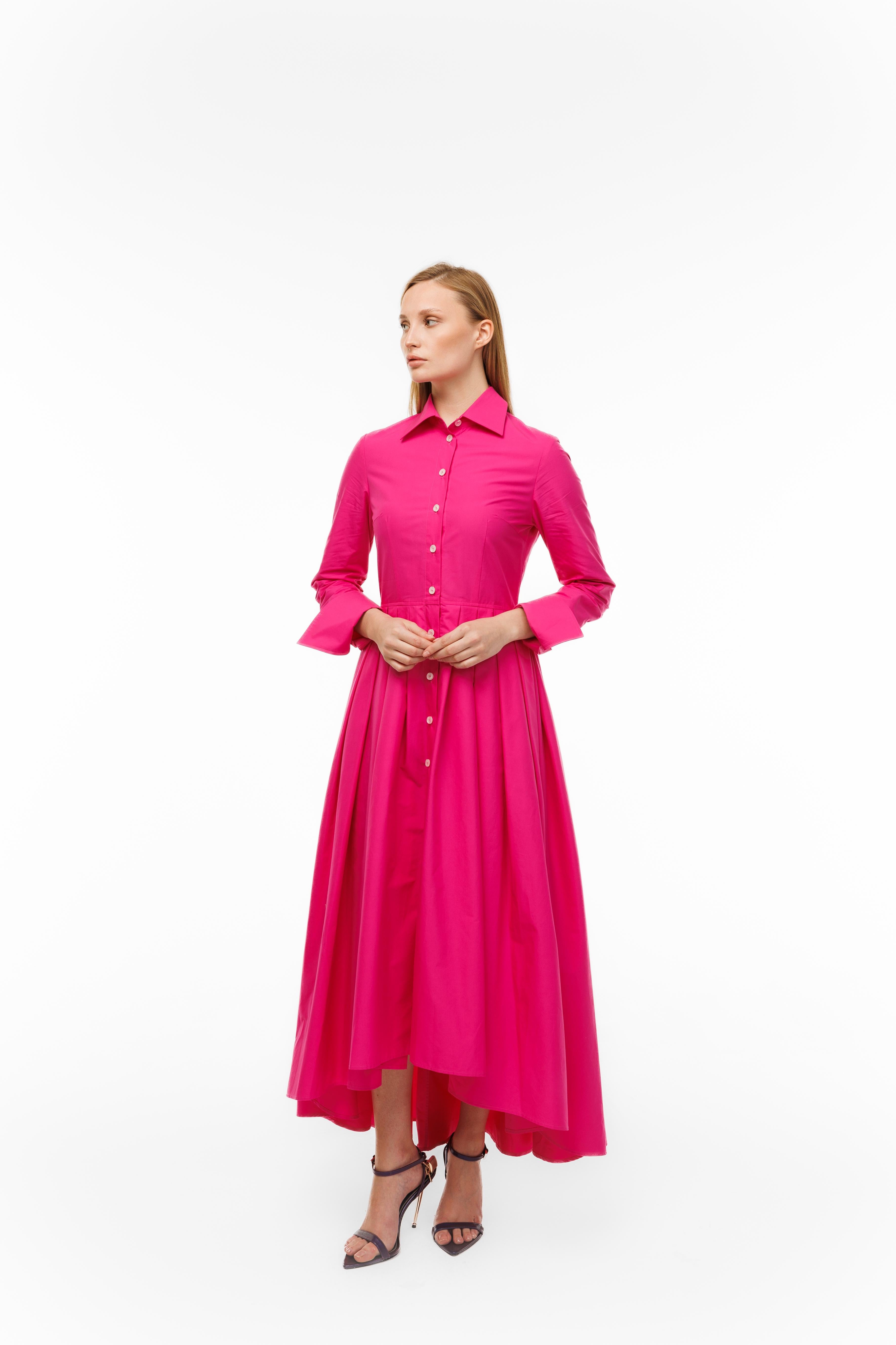 Woman wearing a bright pink dress on a white background