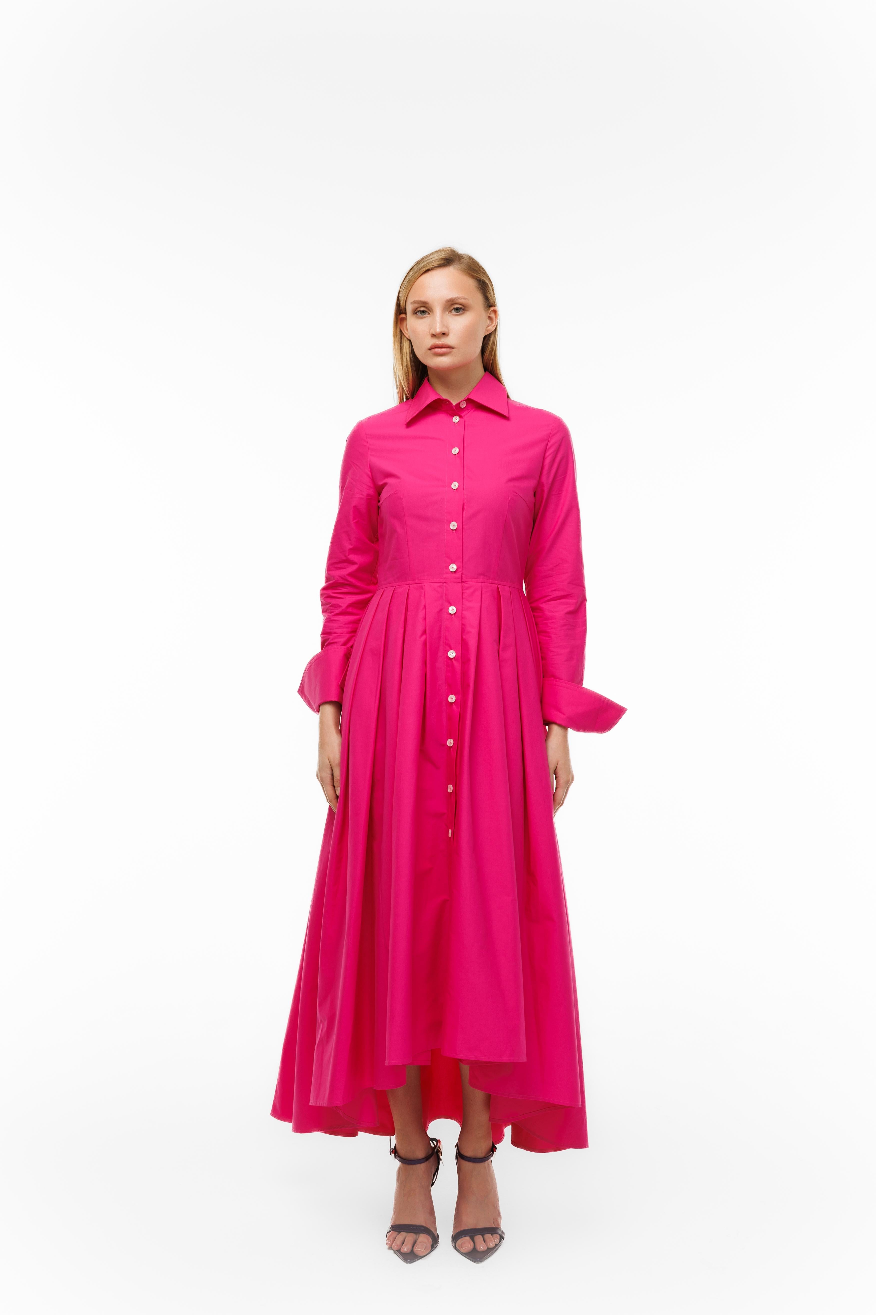 Woman wearing a bright pink dress on a white background