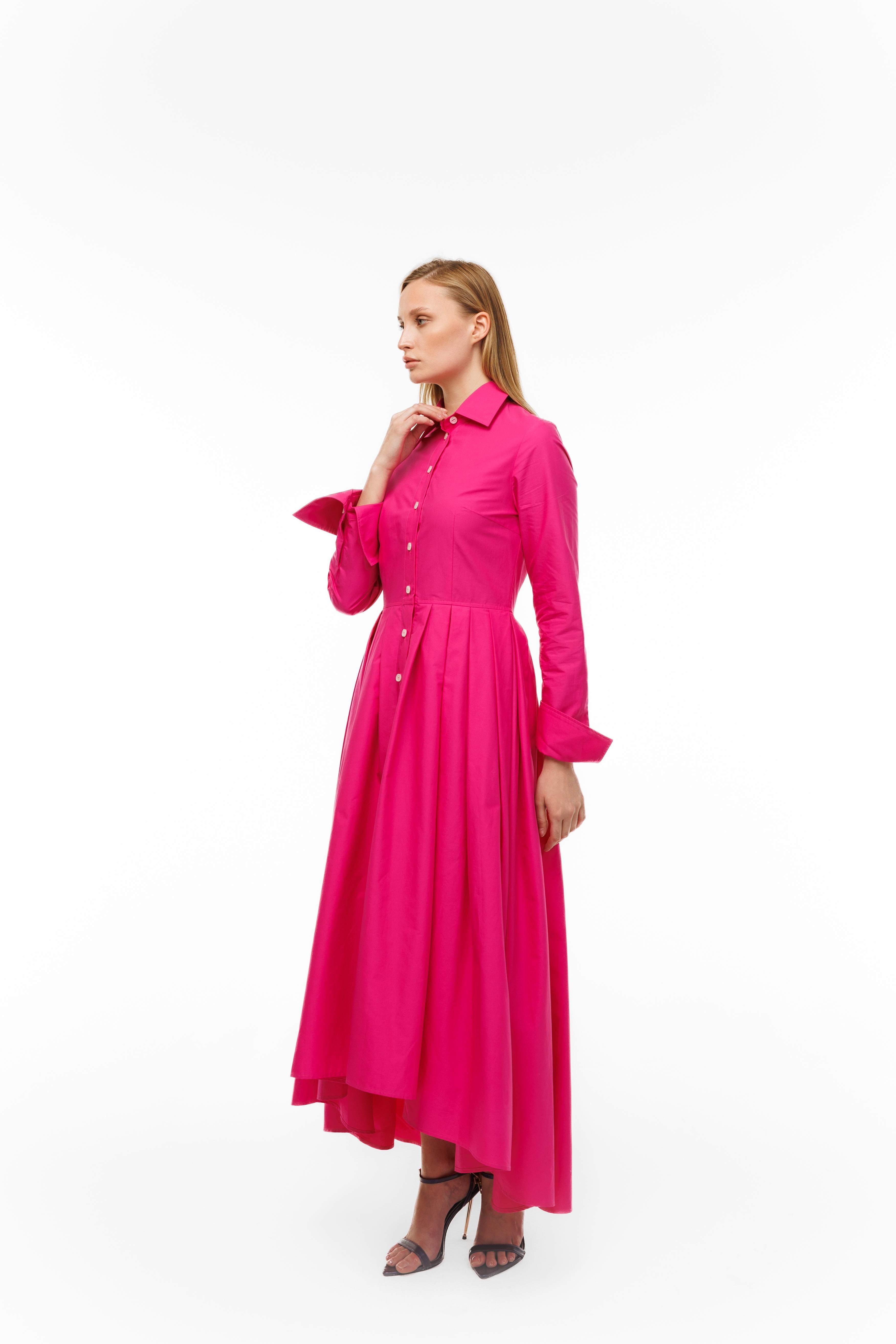 Woman wearing a bright pink dress on a white background