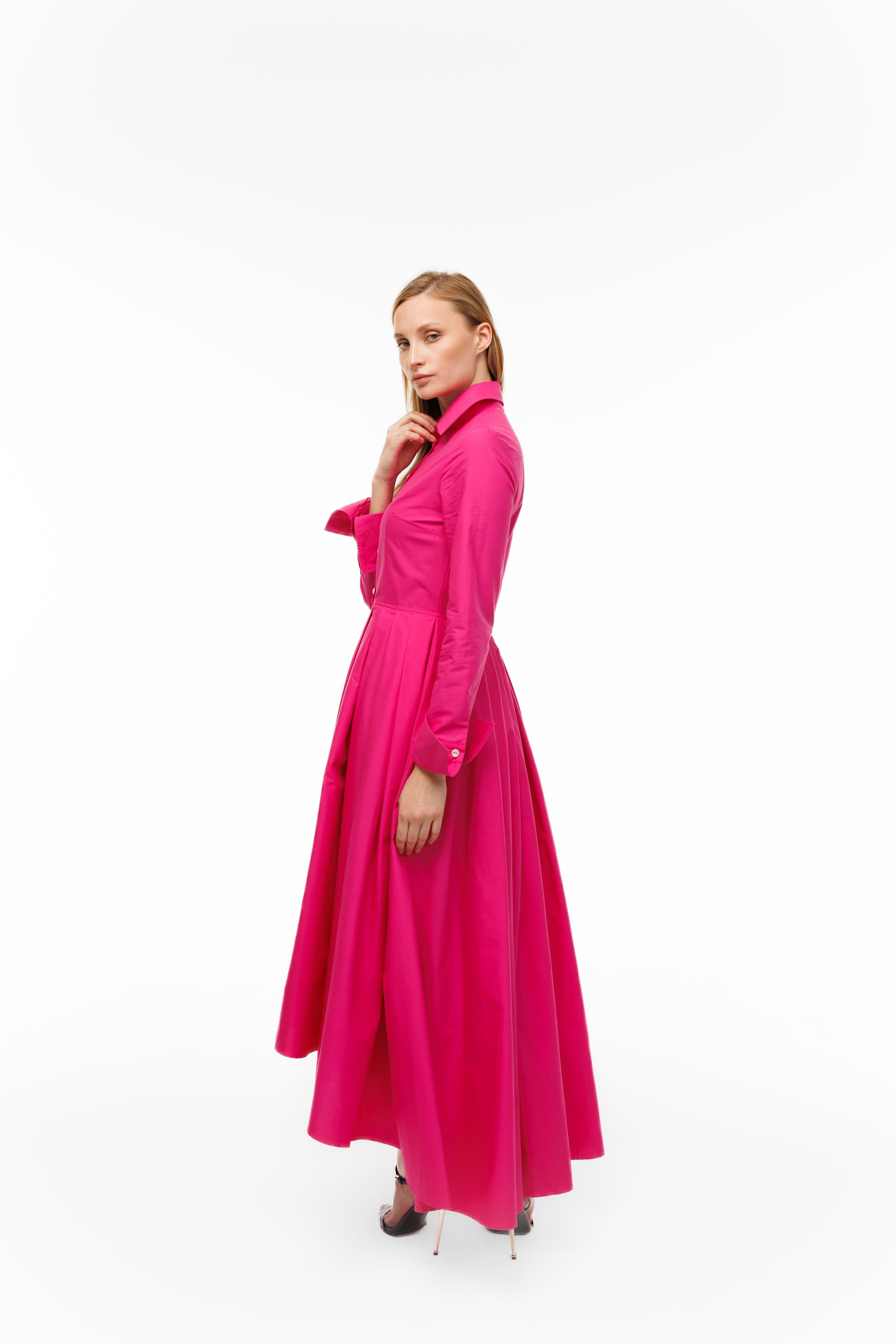 Woman wearing a bright pink dress on a white background