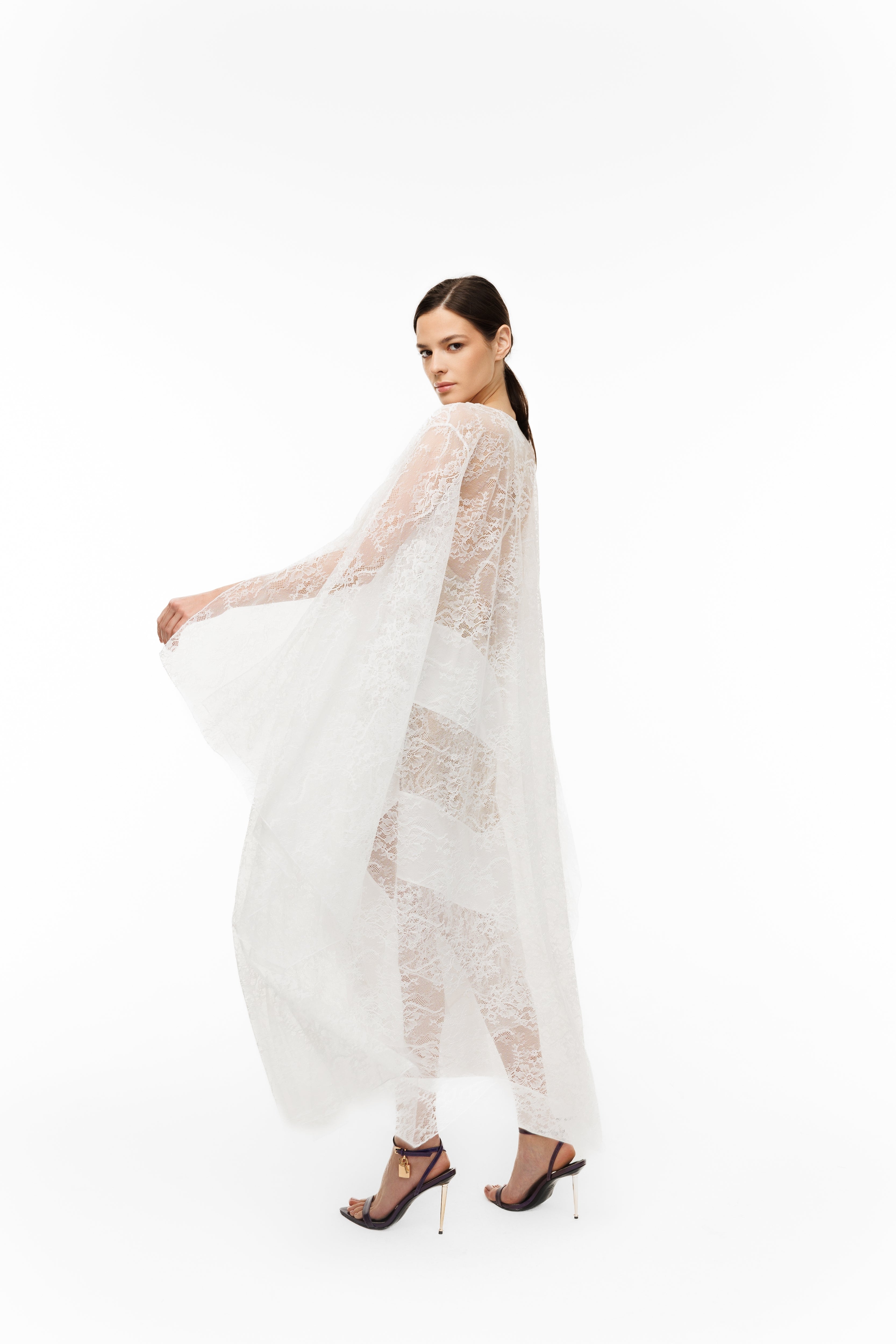 Woman wearing a sheer white outfit on a white background