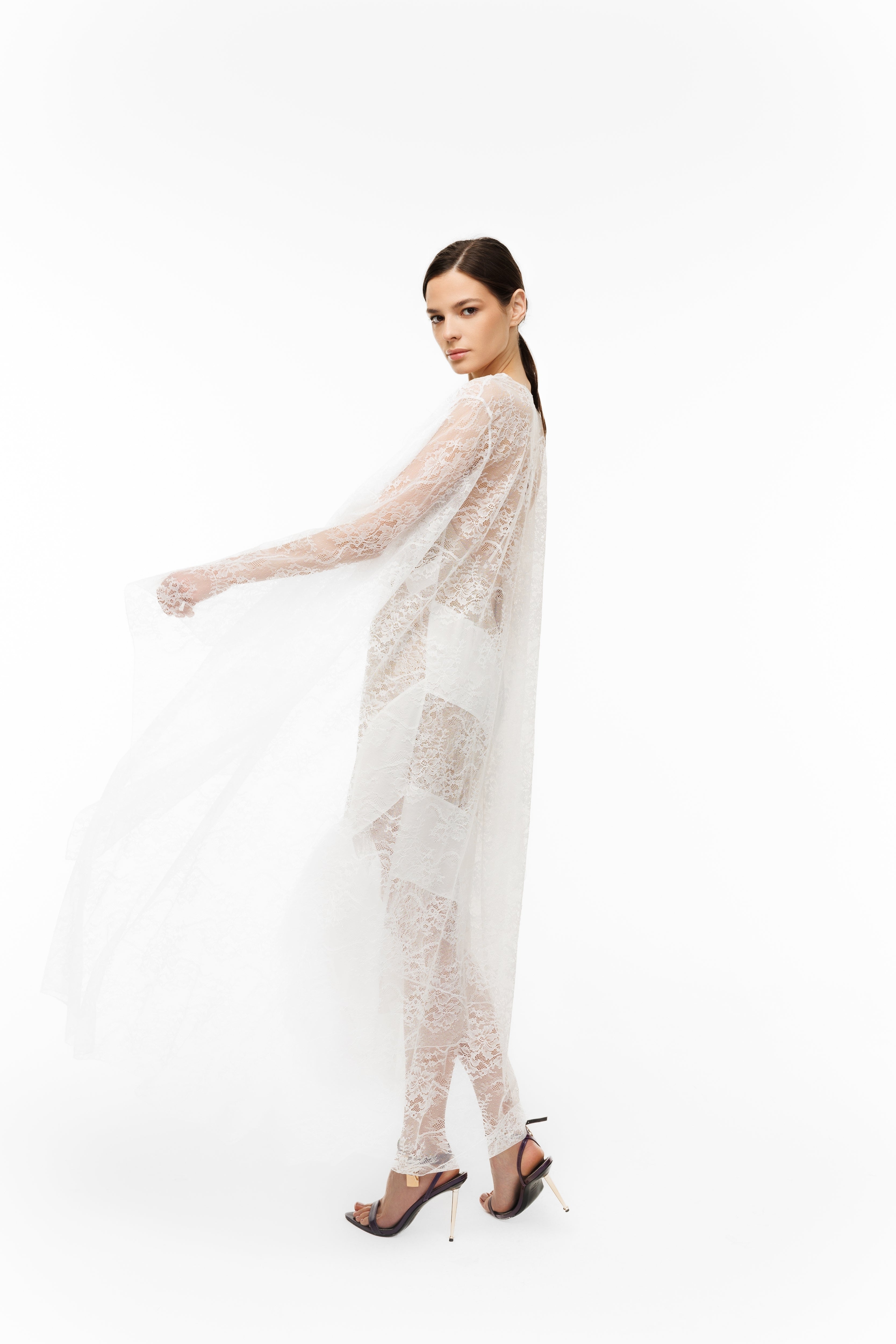 Woman wearing a sheer white outfit on a white background