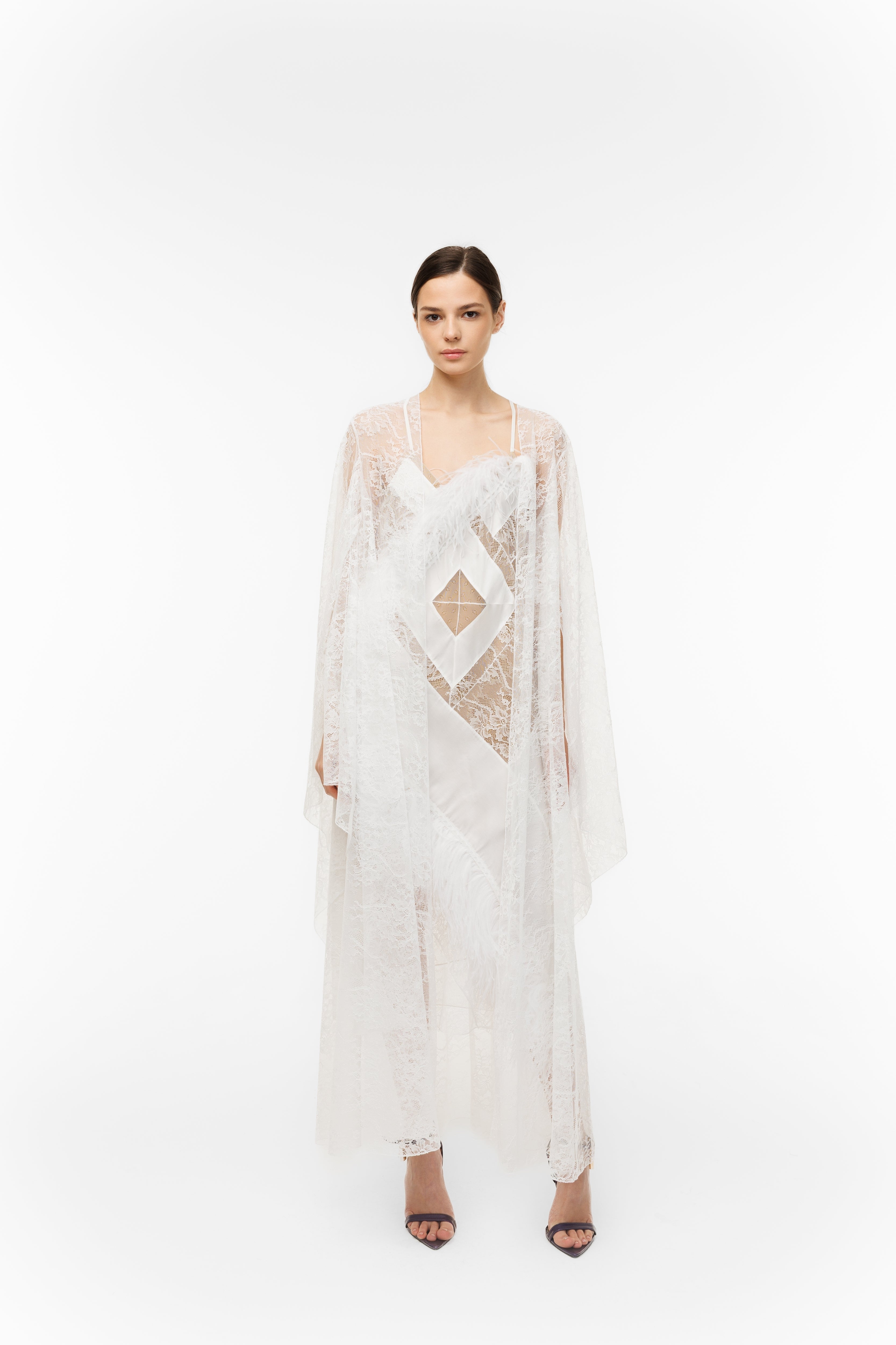Woman wearing a white lace dress on a white background