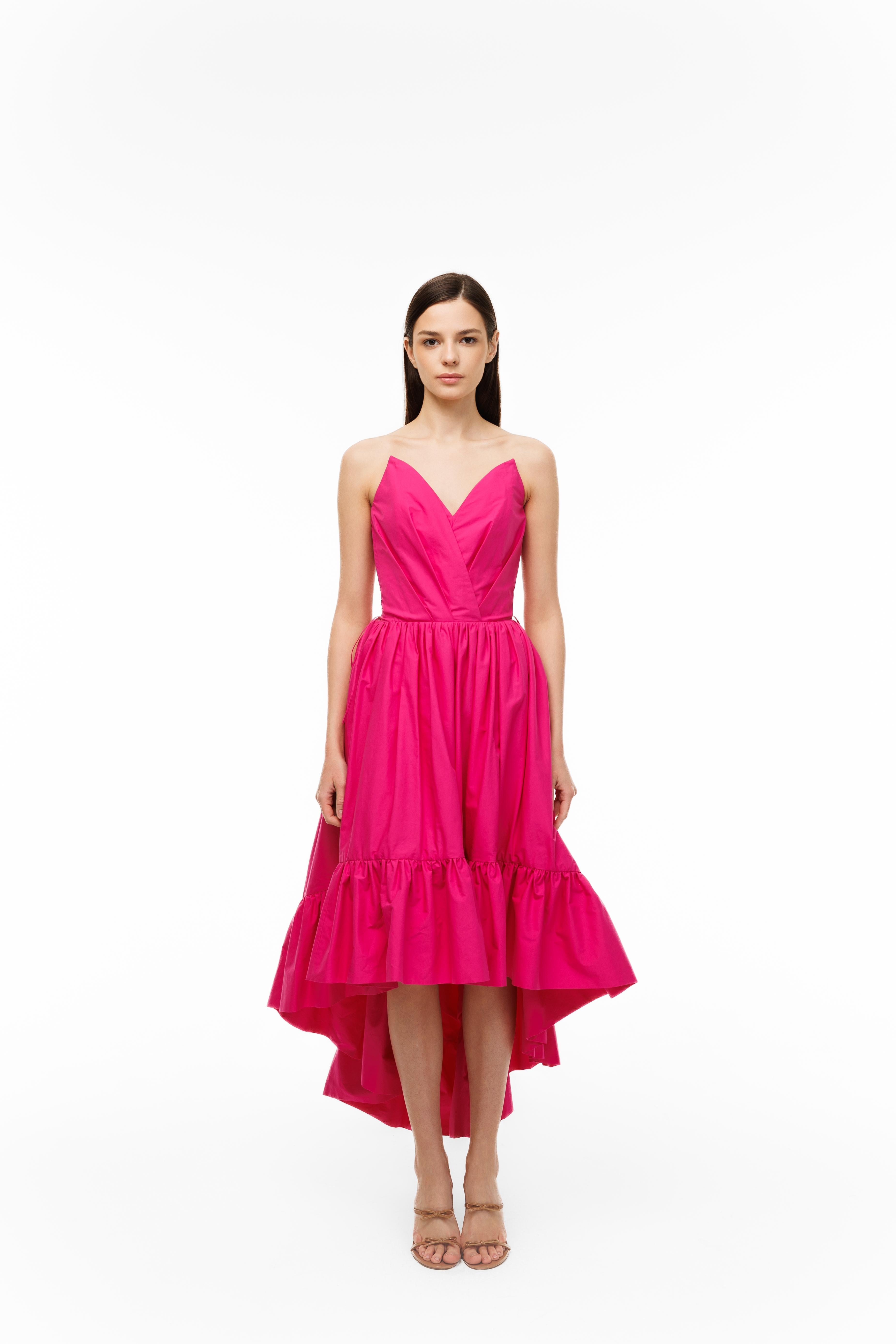 Woman wearing a pink dress on a white background
