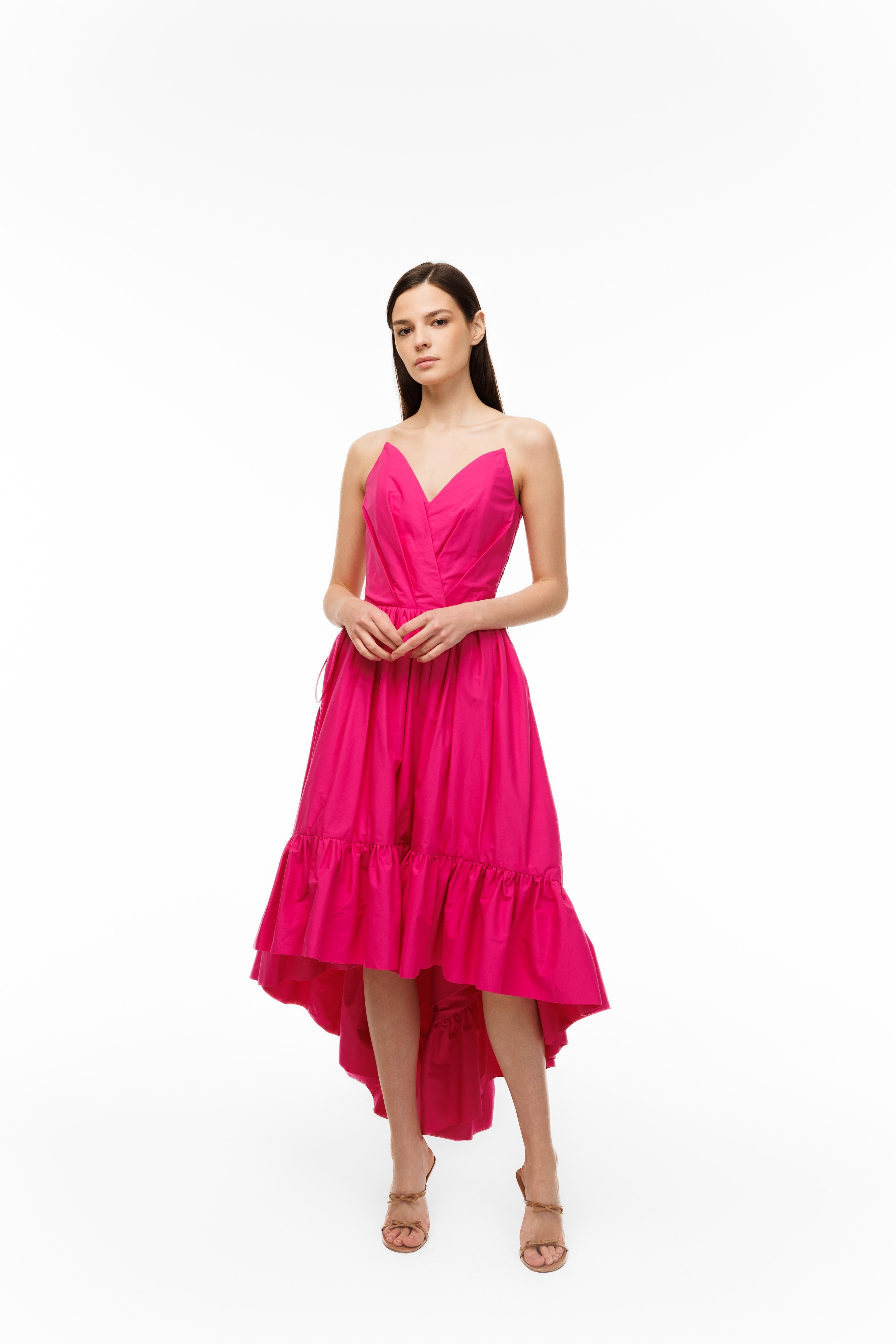 Woman wearing a pink dress on a white background