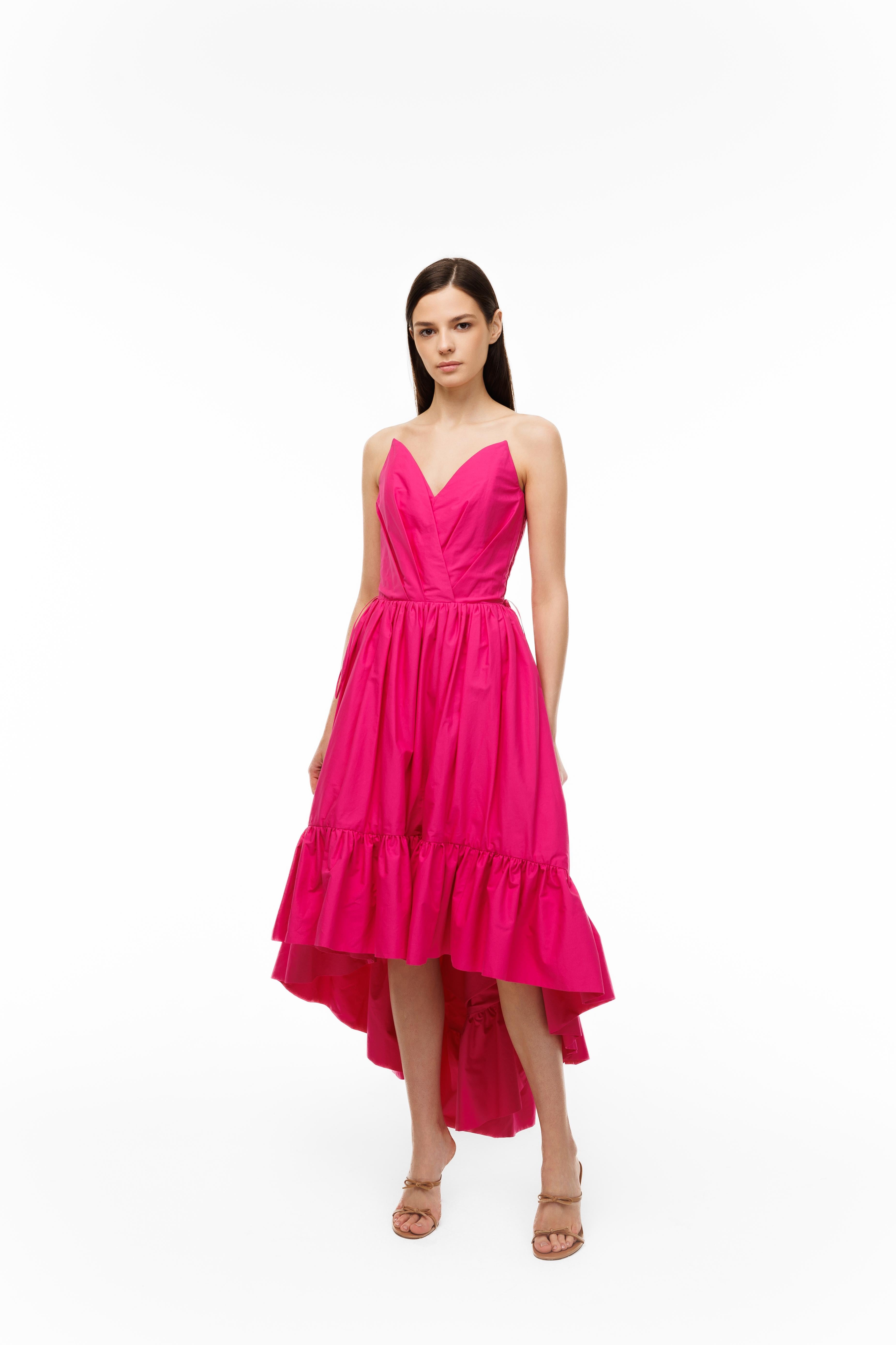 Woman wearing a pink dress on a white background
