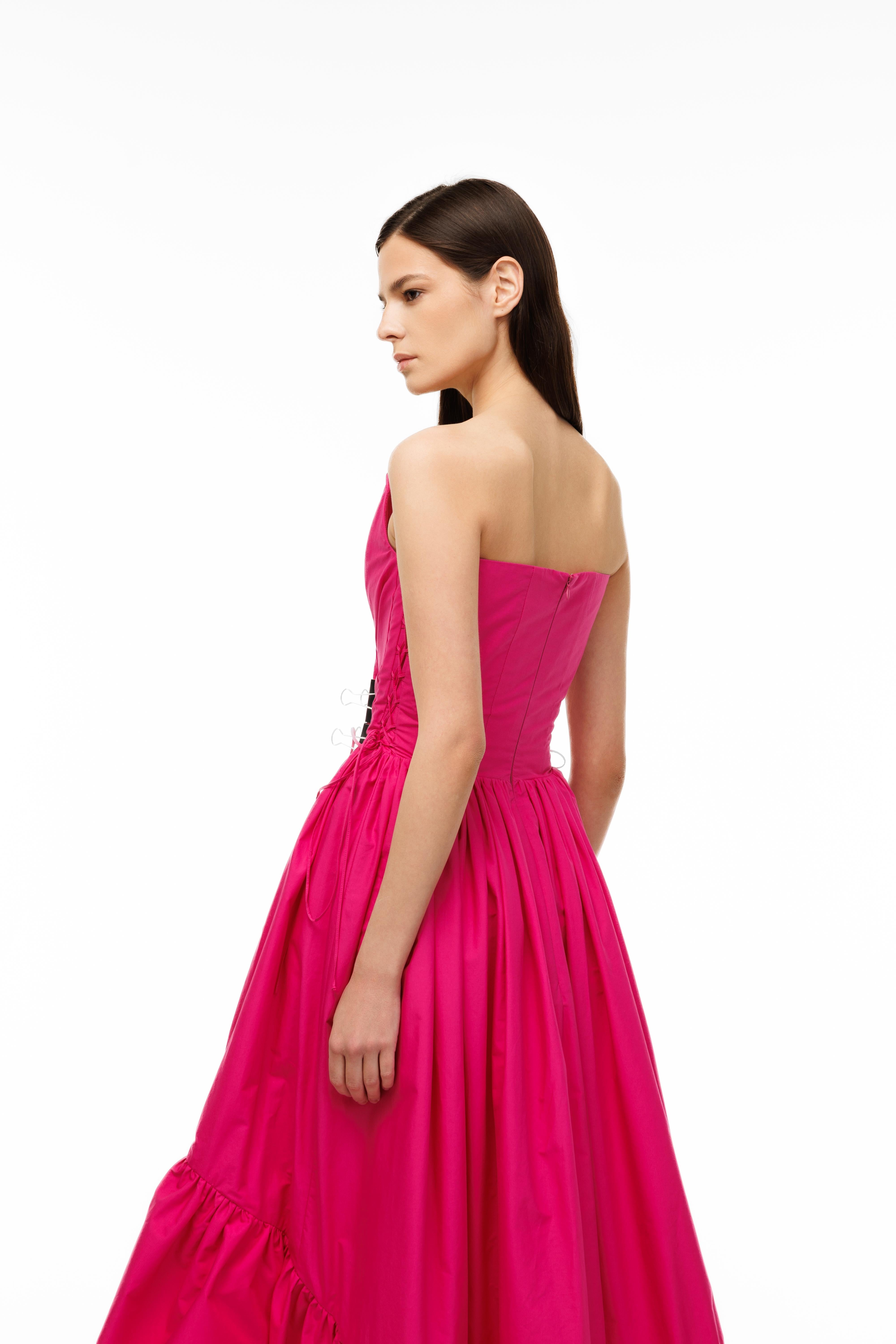 Woman wearing a pink evening gown on a white background