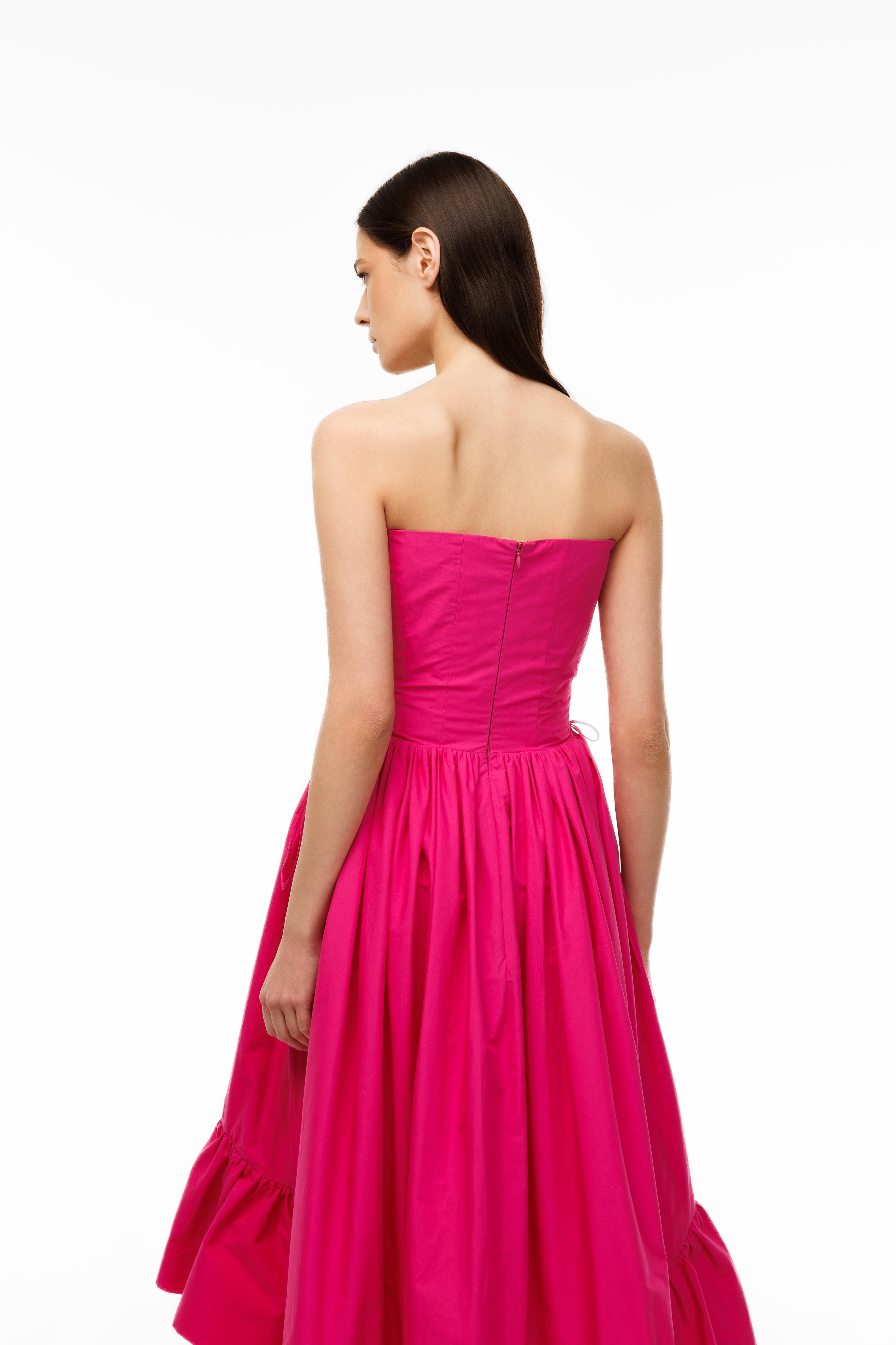 Woman wearing a strapless pink gown on a white background