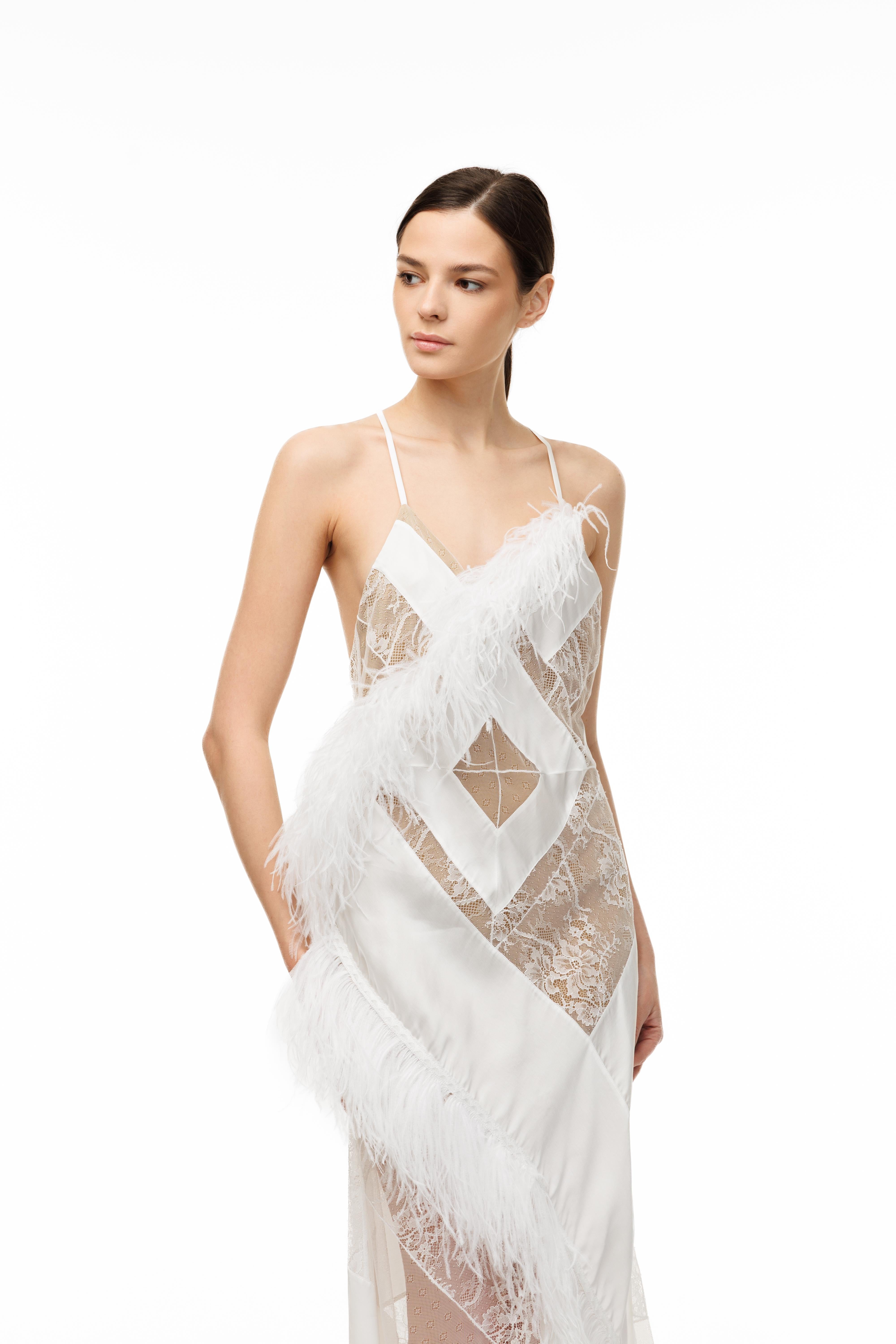Woman wearing a white lace dress on a white background