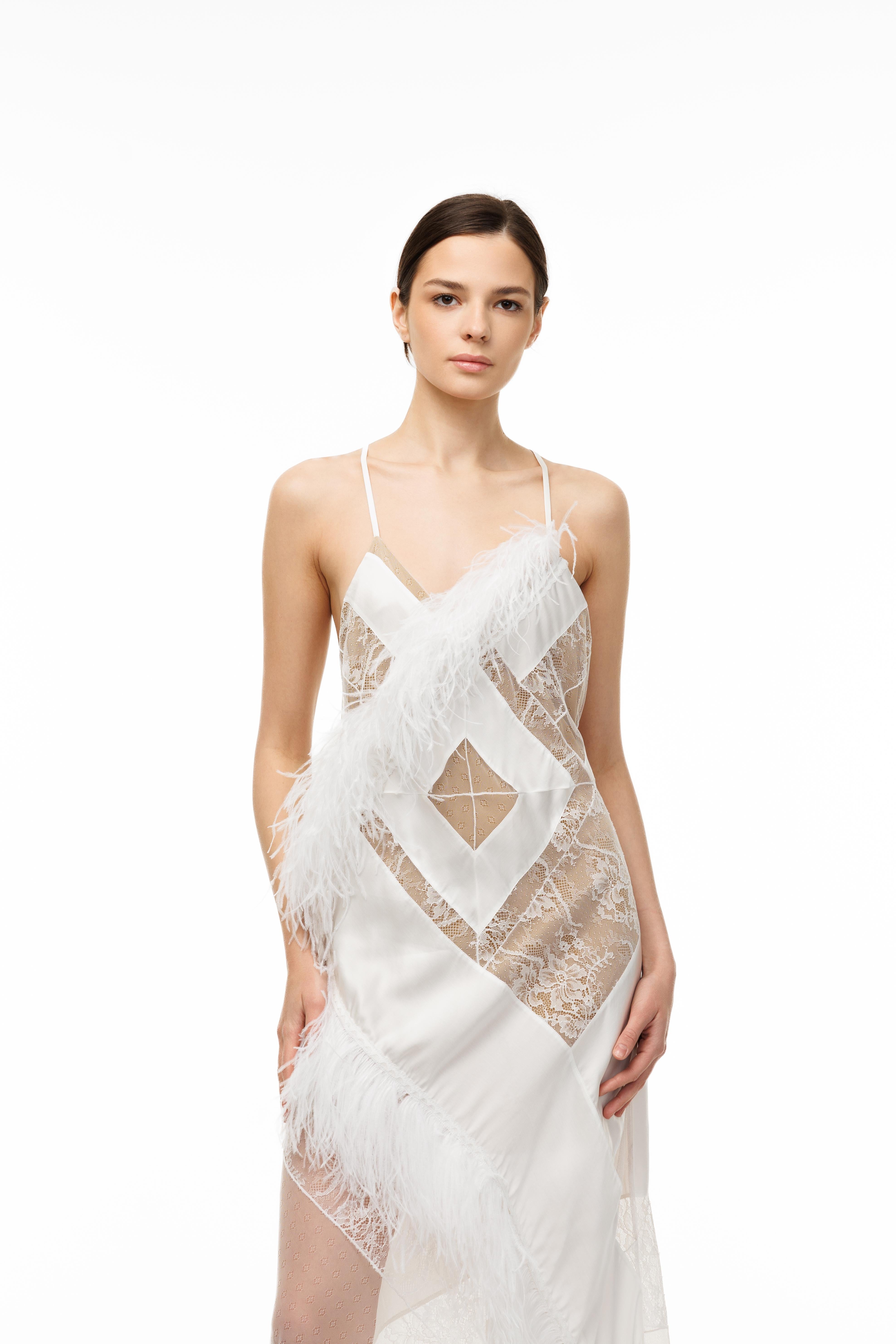 Woman wearing a white lace dress on a white background